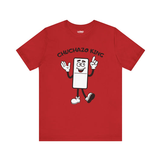 A red t-shirt with a graphic print of a smiling cartoon domino piece with the text 'Chuchazo KING' on the front.