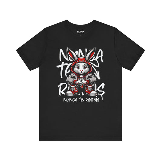 Black t-shirt with graphic print of a stylized bunny wearing a red hoodie and the text 'Nunca Te Rindas' in bold lettering.