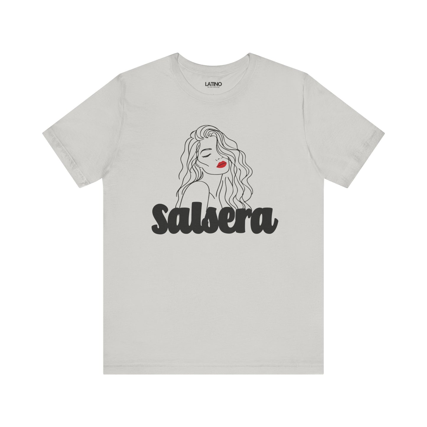 White crew neck t-shirt with a graphic line drawing of a woman's face, predominantly in shades of gray and black, with the word 'SALSERA' written across the lower part.