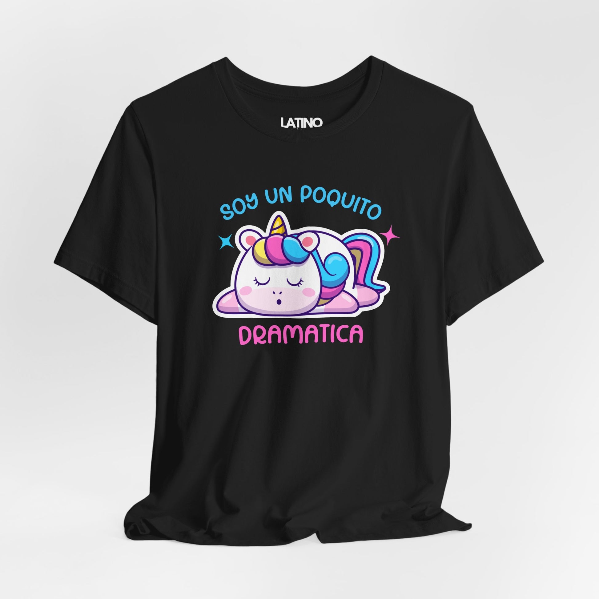 Black T-shirt with a cute pastel unicorn laying down and the text “Soy Un Poquito Dramática” in blue and pink bubble letters.