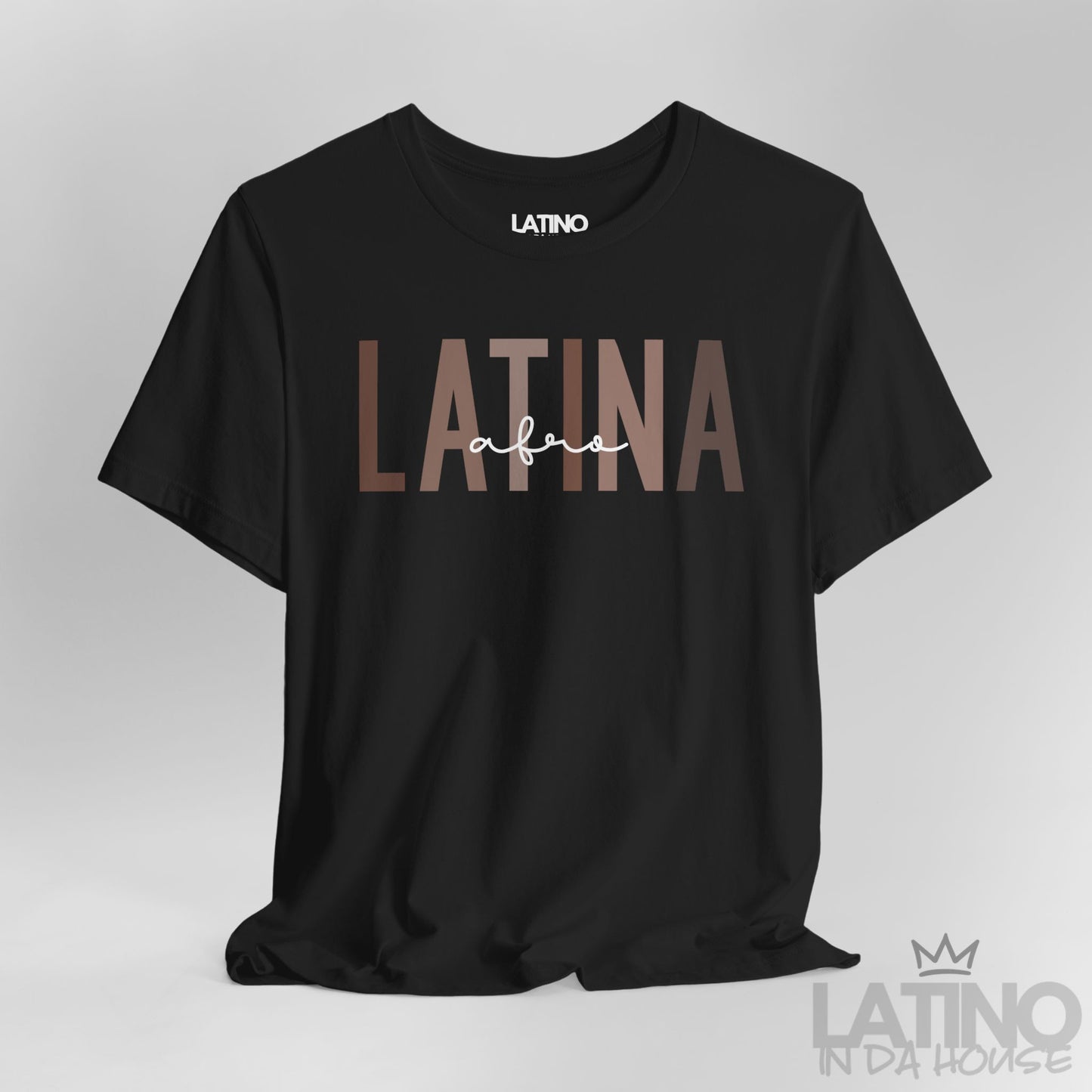Close-up of Afro Latina T-Shirt design in bold brown text on black cotton fabric. Latino In Da House