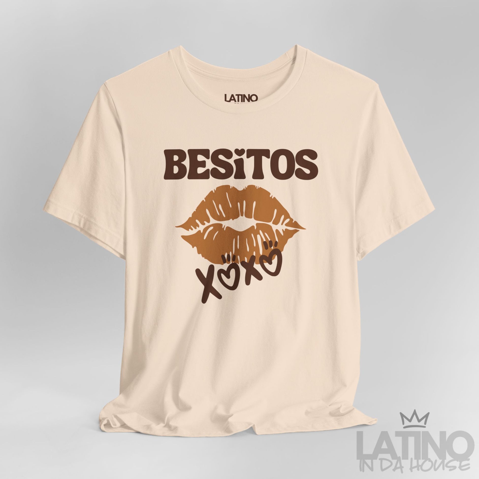 Close up of soft cream Besitos XOXO T-Shirt with brown lips graphic. Latino In Da House