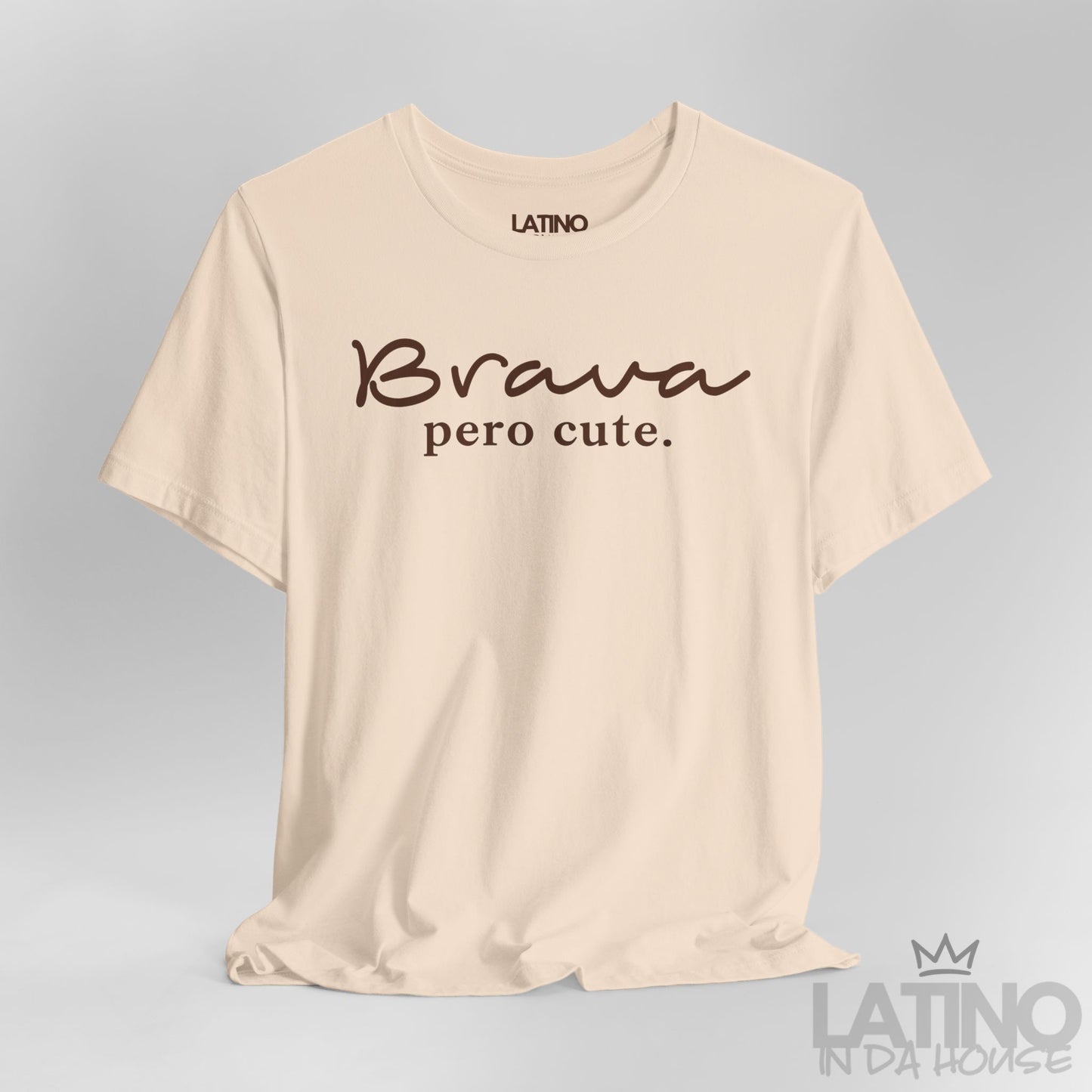 Detailed view of Brava Pero Cute T-shirt in brown script lettering on soft cream fabric, Latino In Da House design.