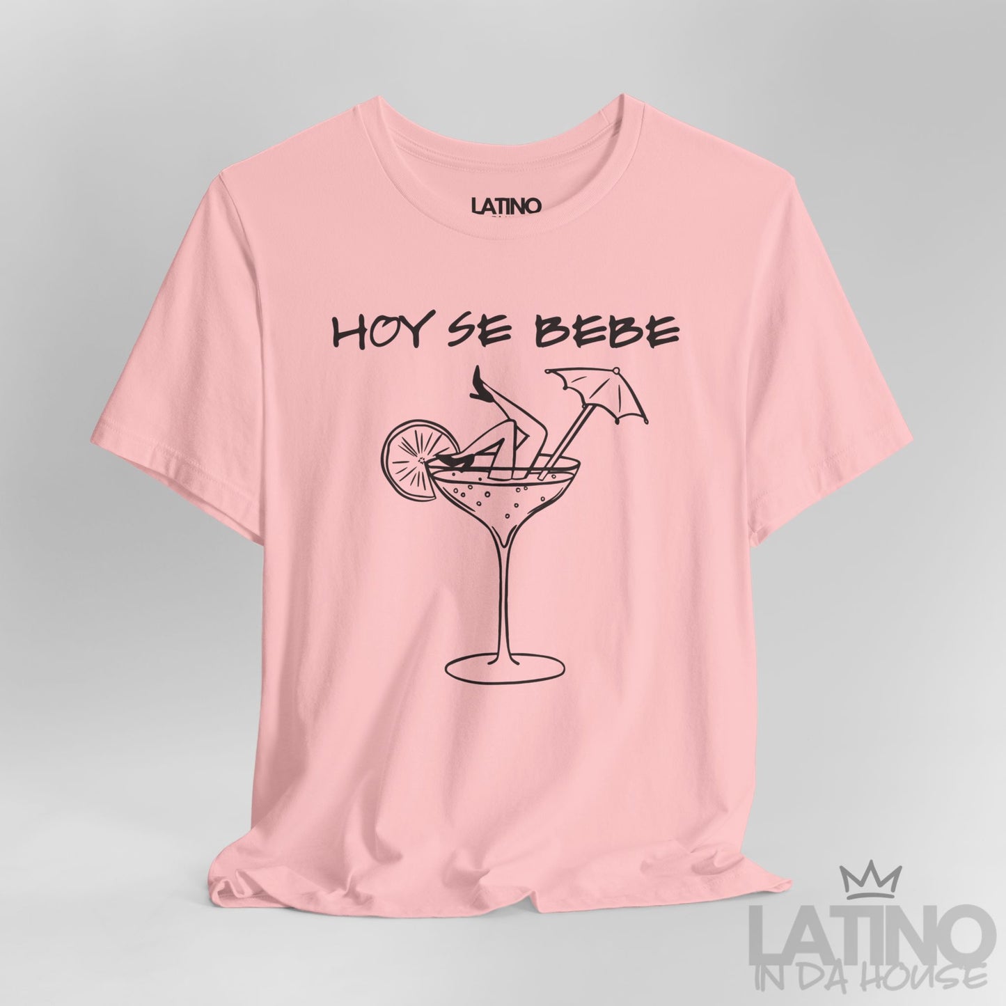Close-up of pink T-shirt design with Hoy Se Bebe phrase and cocktail graphic. Latino In Da House