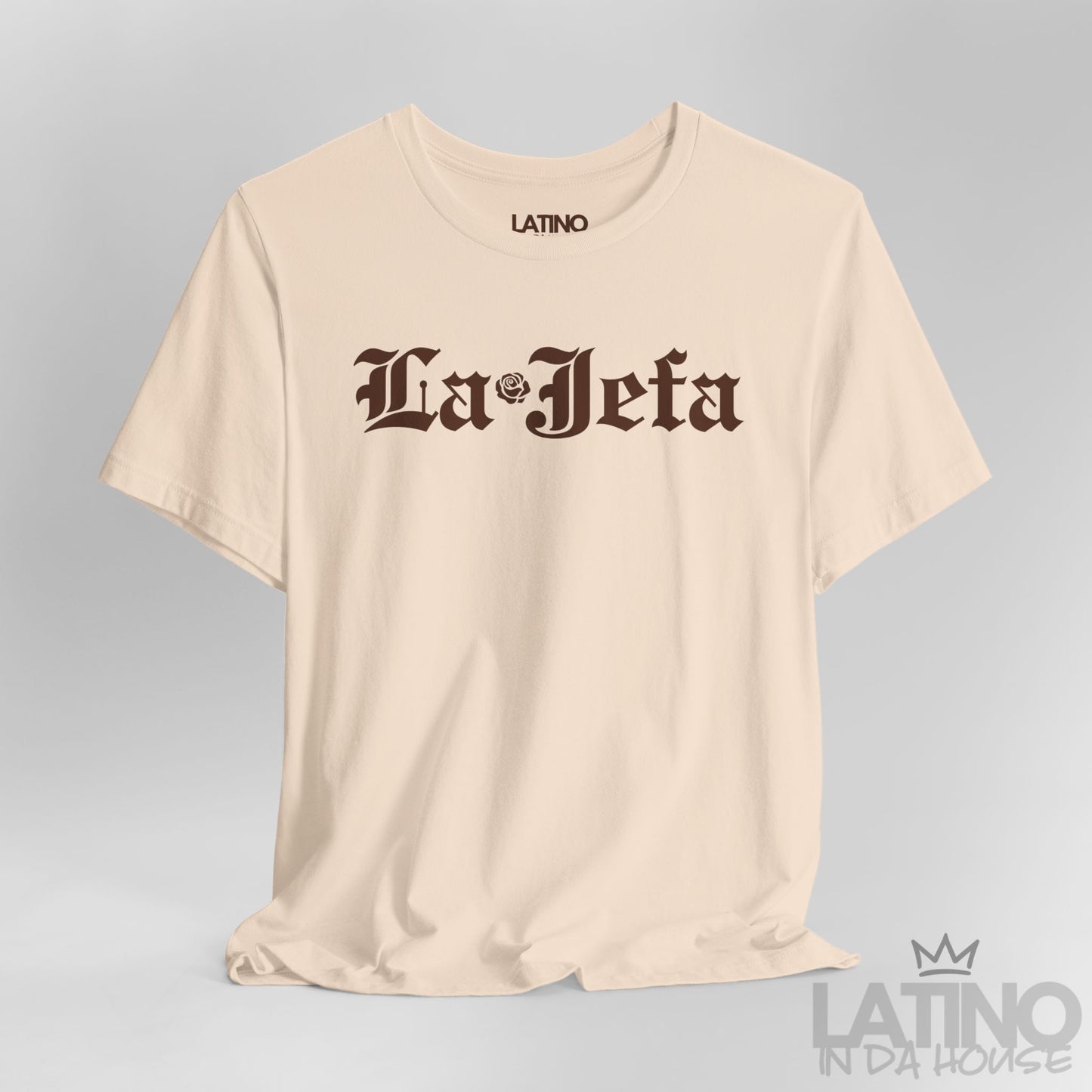 Close-up of La Jefa gothic text and rose detail on soft cream T-shirt. Latino In Da House