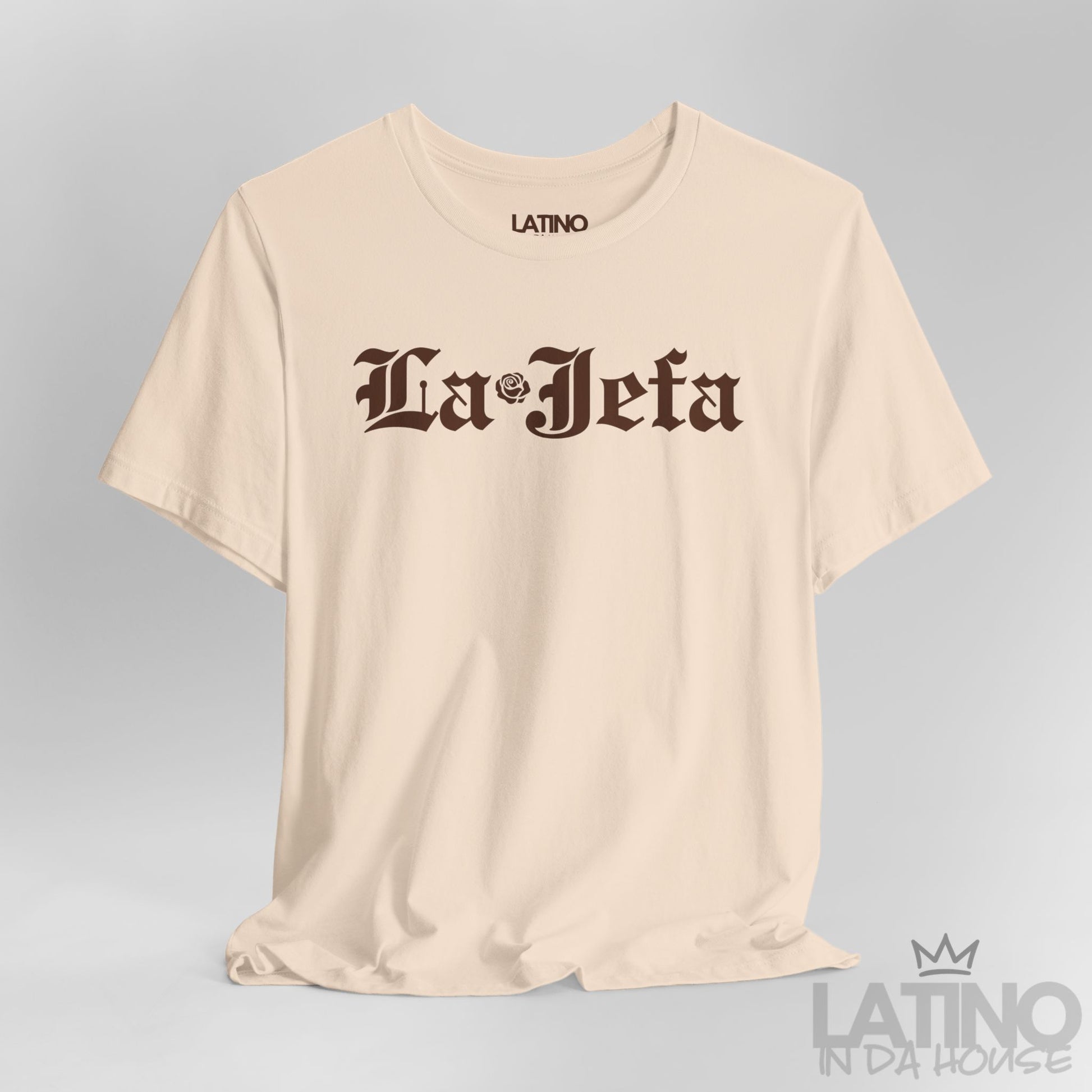 Close-up of La Jefa gothic text and rose detail on soft cream T-shirt. Latino In Da House