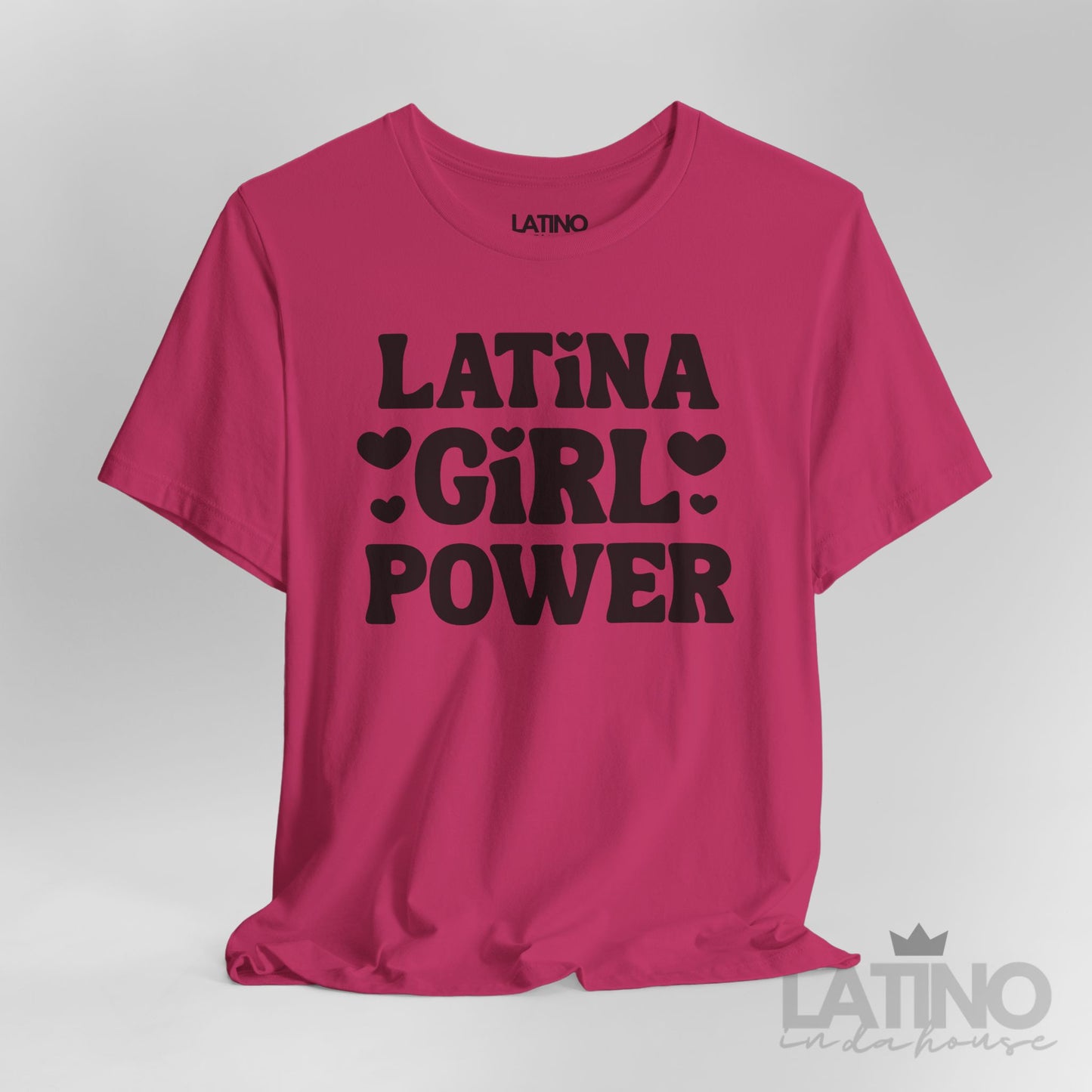 Closeup of Latina Girl Power T-Shirt in berry with bold black lettering and heart accents. Latino In Da House