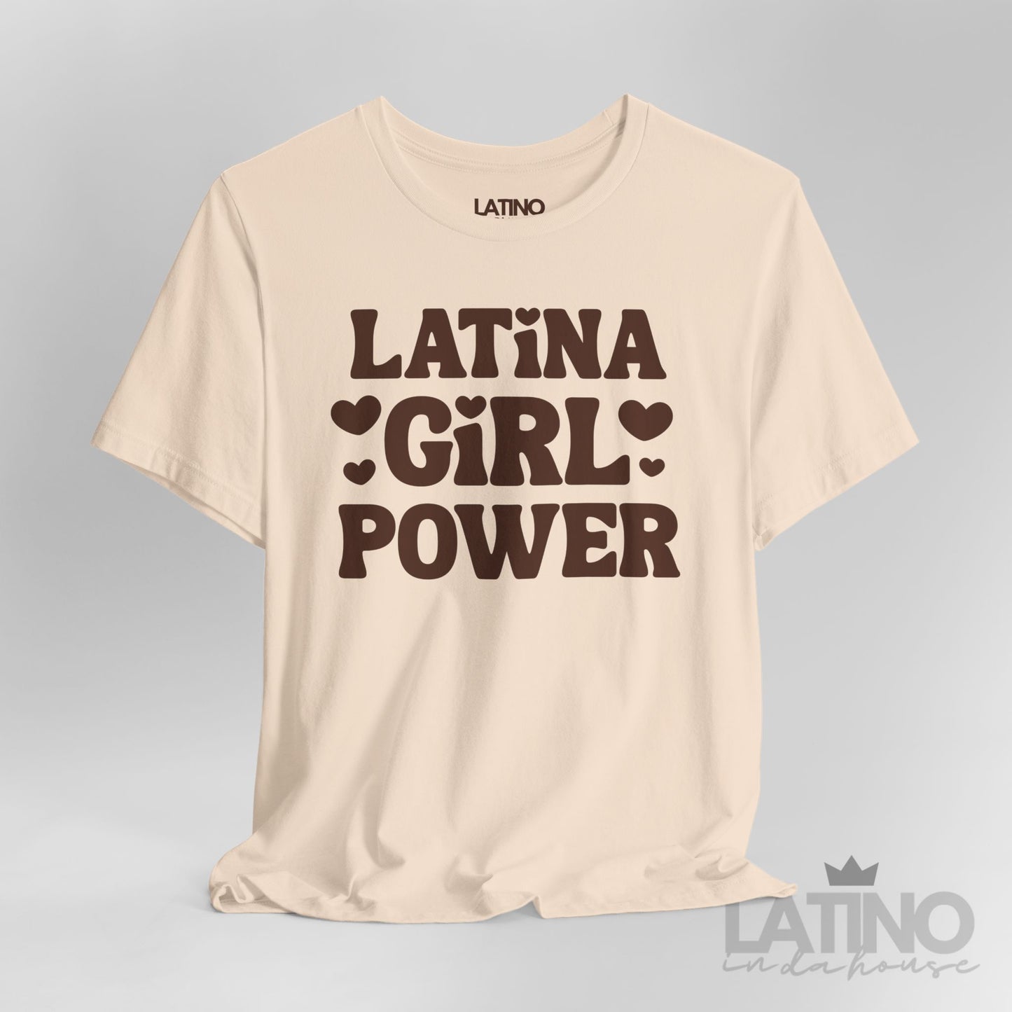 Closeup of Latina Girl Power T-Shirt in cream with bold brown lettering and heart accents. Latino In Da House