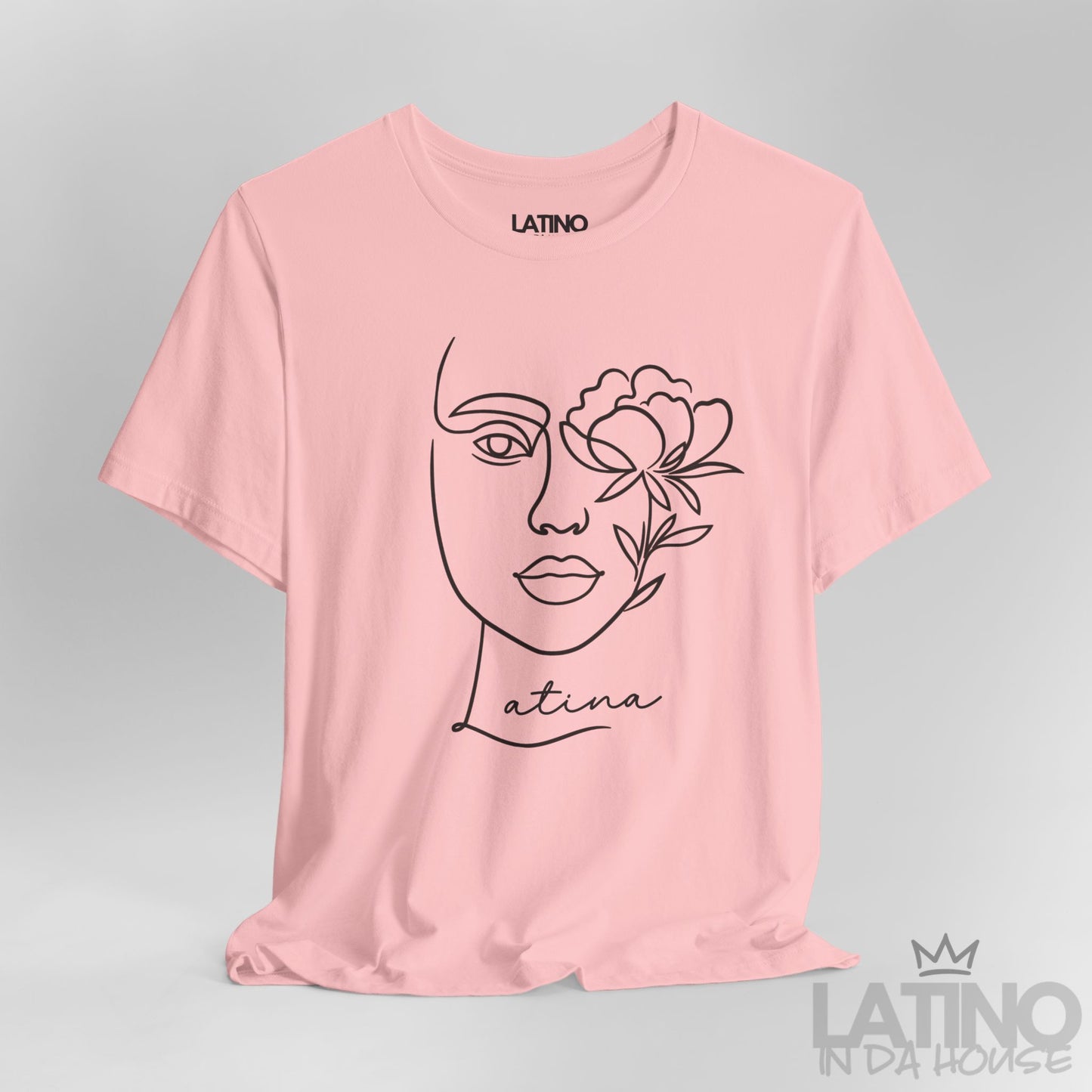 Close-up of Latina T-shirt with minimalist face and flower line art in Pink. Latino In Da House
