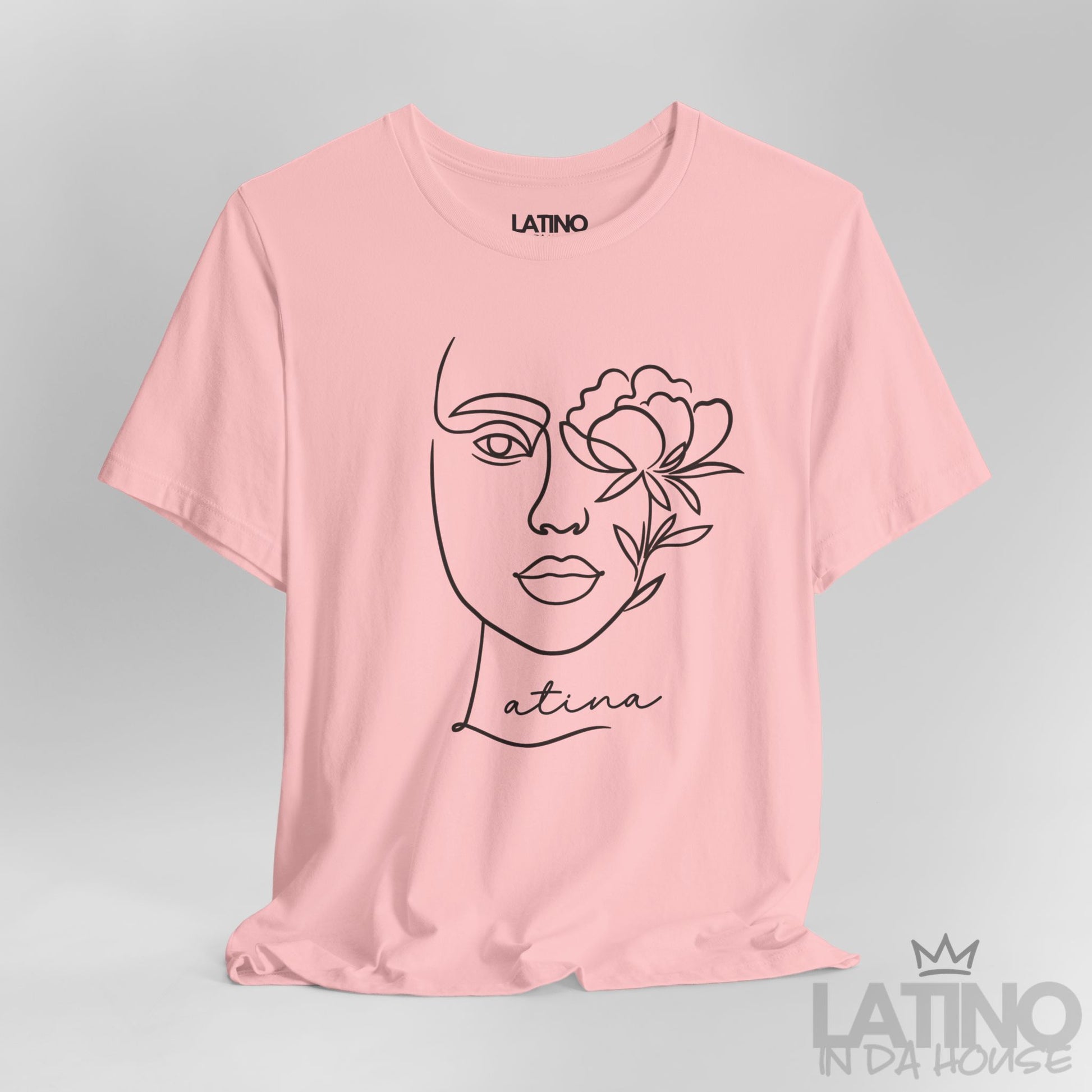 Close-up of Latina T-shirt with minimalist face and flower line art in Pink. Latino In Da House