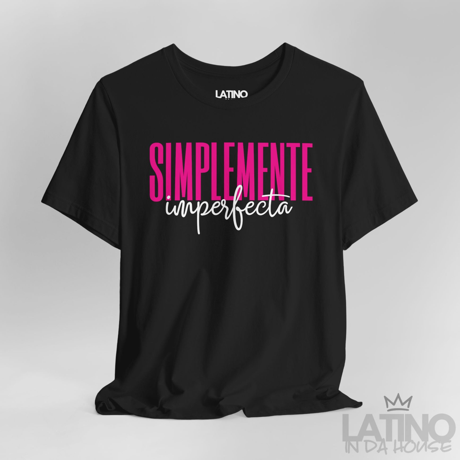 Close up of black T-shirt with bold pink and white text reading “Simplemente Imperfecta” – Latino In Da House