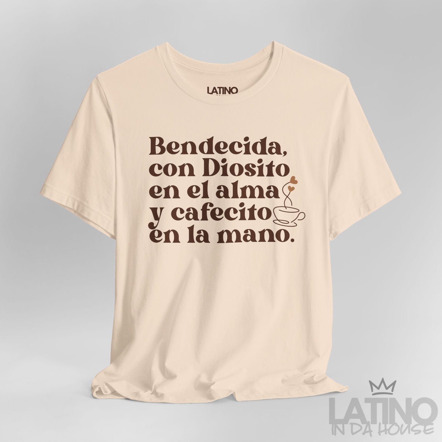 Close-up of Bendecida con Diosito y Cafecito Soft Cream T-Shirt showing coffee cup and Spanish faith quote. Latino In Da House