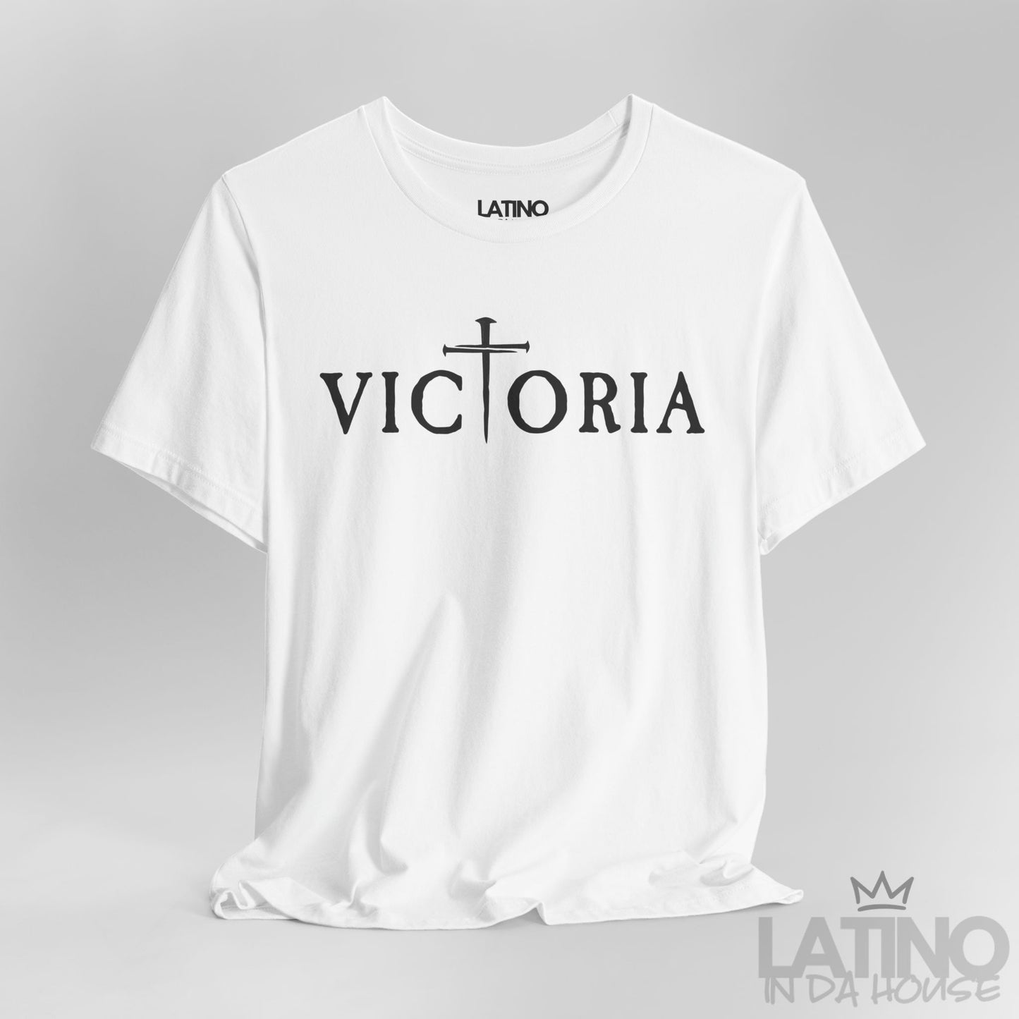 Close-up of Victoria White T-Shirt showing gothic lettering and cross forming the T. Latino In Da House
