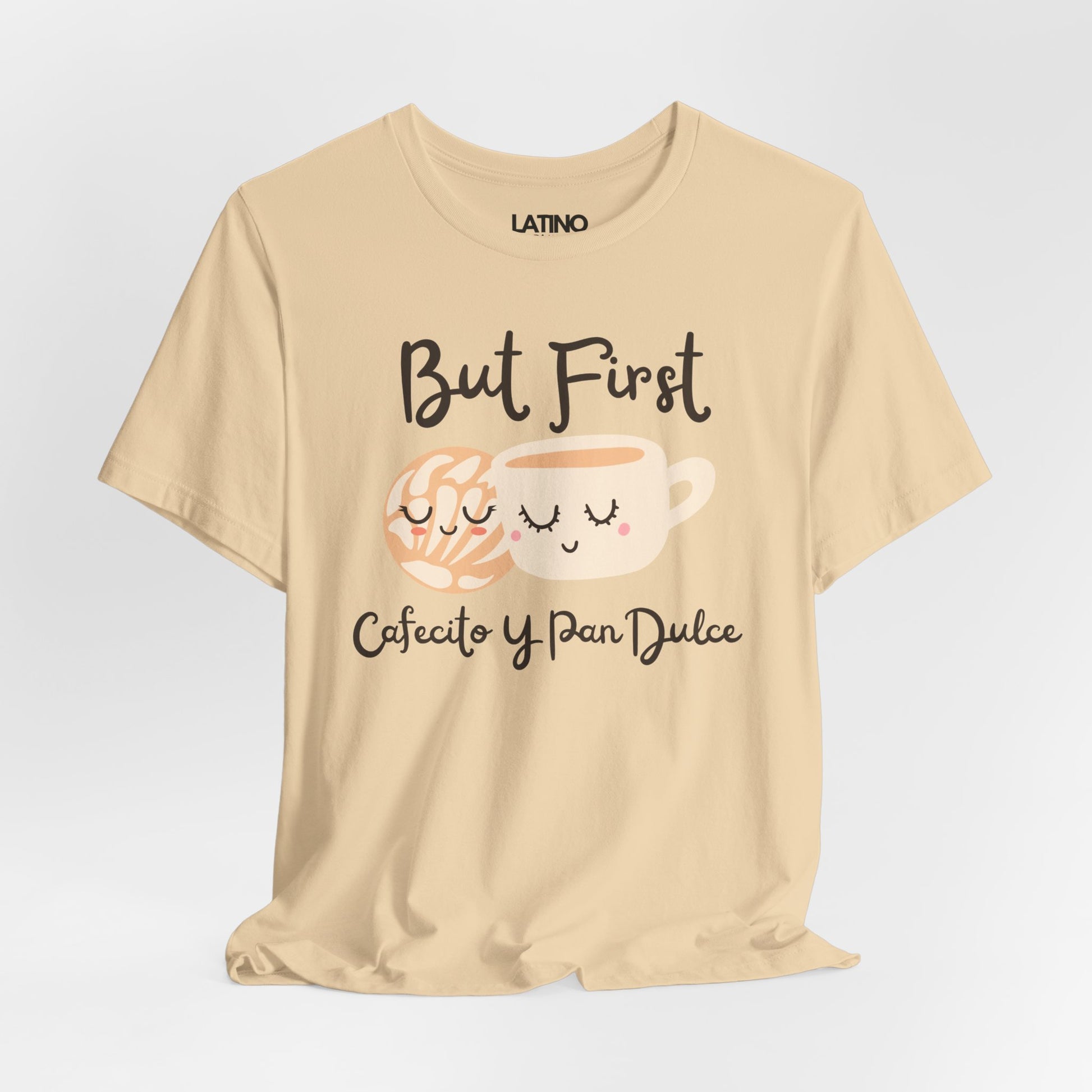 Beige t-shirt with coffee and cake graphics and text on a light gray background