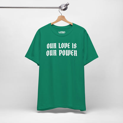 Green t-shirt with 'OUR LOVE IS OUR POWER' text on a hanger against a white background