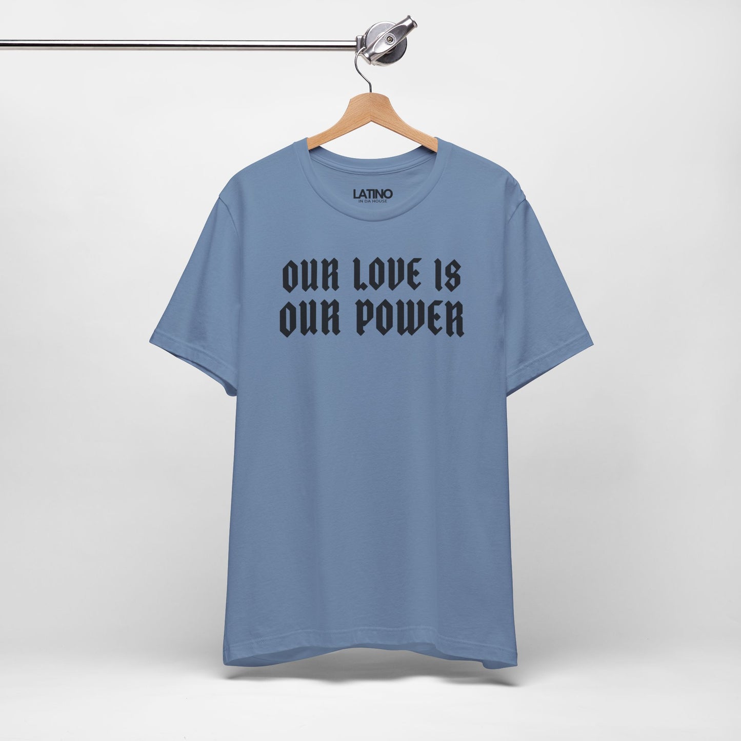 Blue t-shirt with text on a hanger against a white background