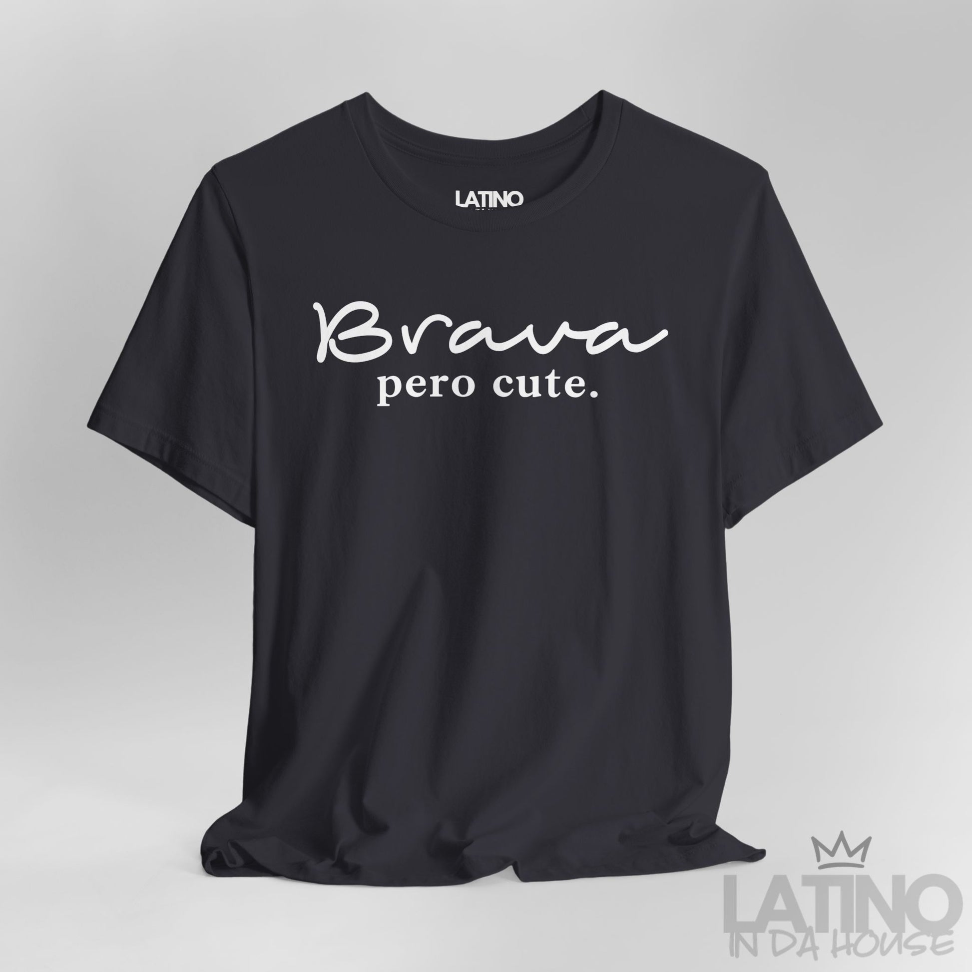 Close-up of Brava Pero Cute T-shirt design in white text on dark grey fabric, modern Latina style.