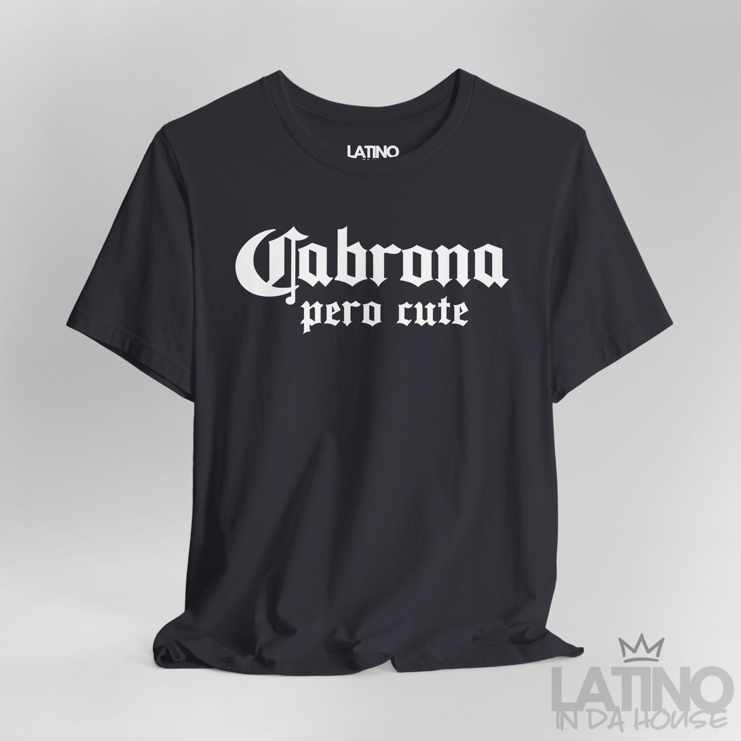 Close-up of dark grey “Cabrona Pero Cute” T-Shirt white gothic text. Latino In Da House