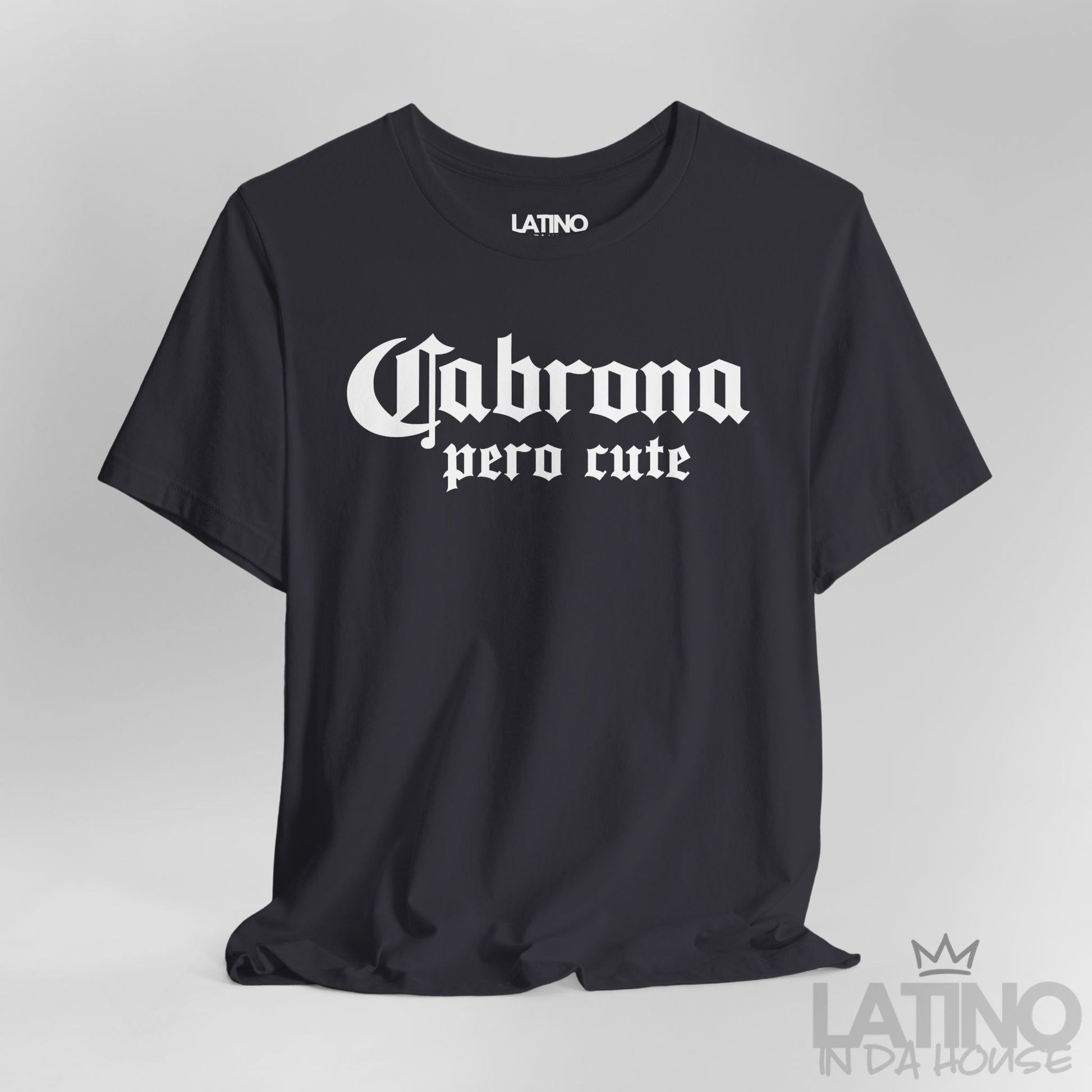 Close-up of dark grey “Cabrona Pero Cute” T-Shirt white gothic text. Latino In Da House