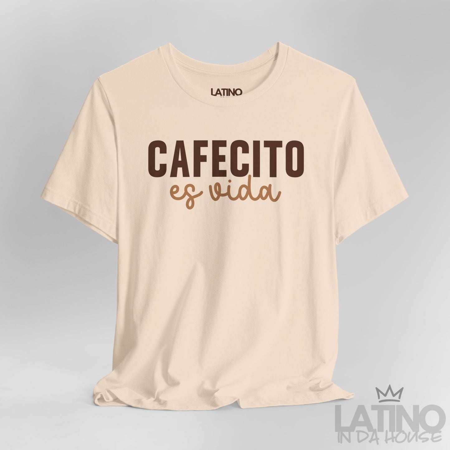 Close up view of Cafecito Es Vida design on soft cream shirt. Latino In Da House 