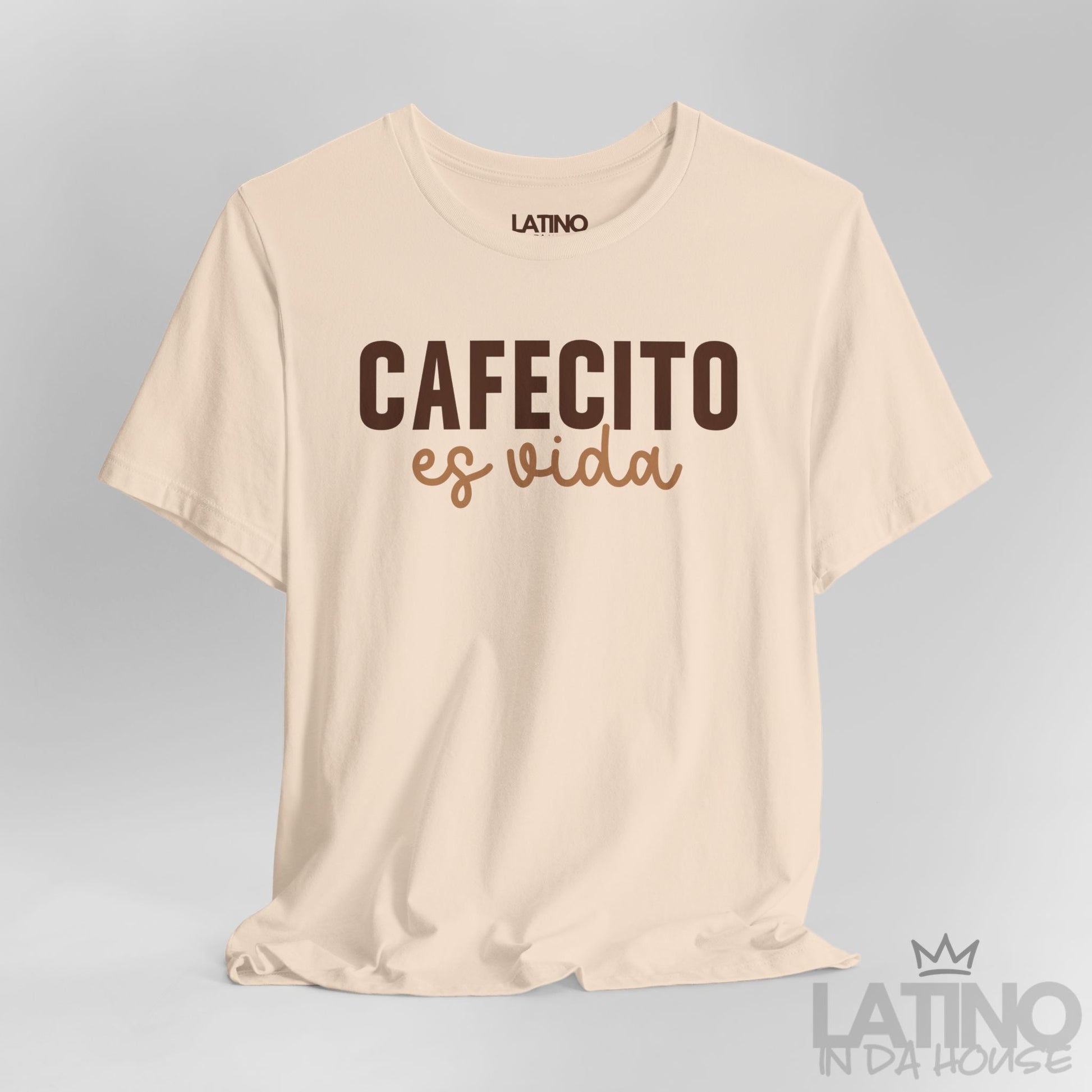 Close up view of Cafecito Es Vida design on soft cream shirt. Latino In Da House 