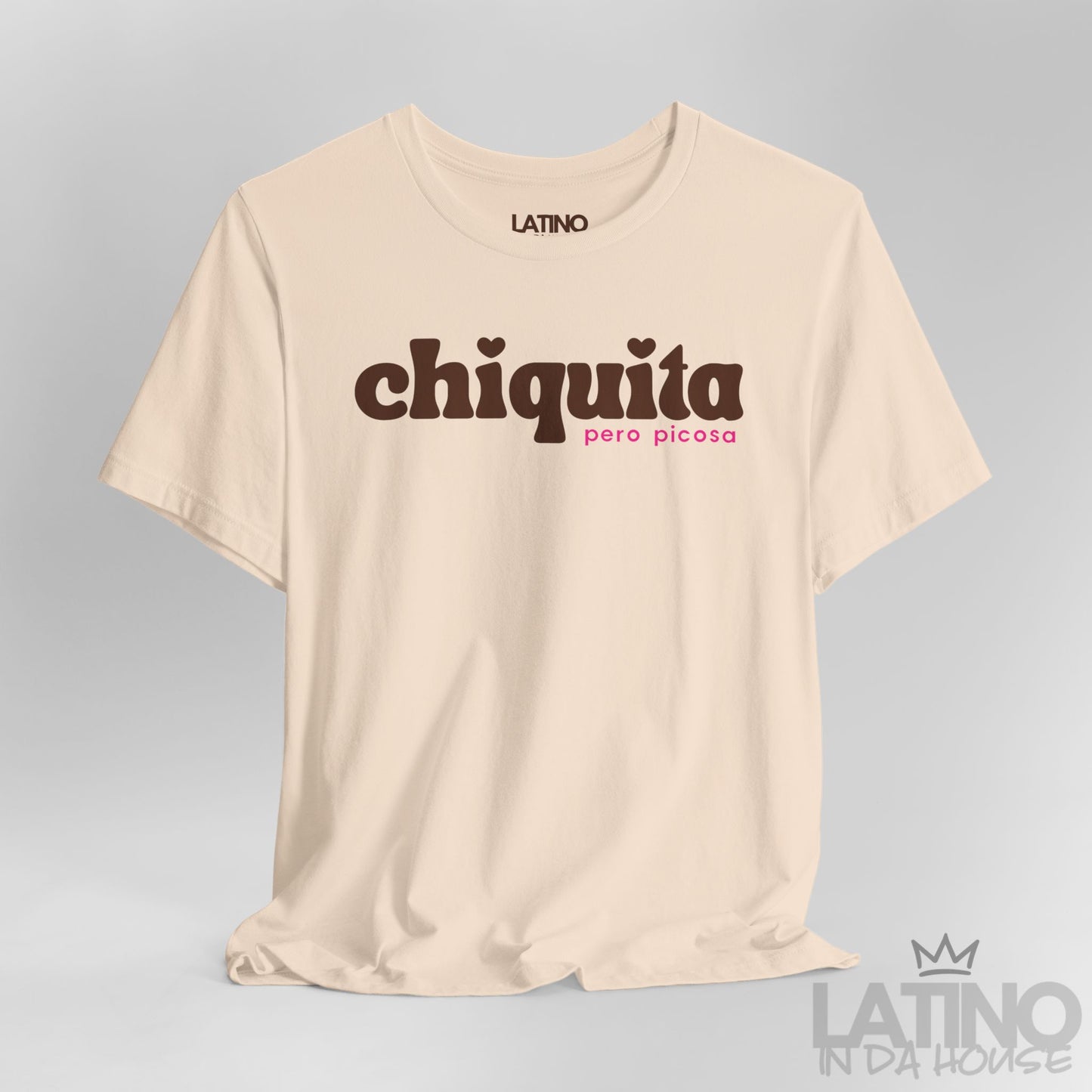 Close-up of soft cream “Chiquita Pero Picosa” T-shirt design showing detail. Latino In Da House 