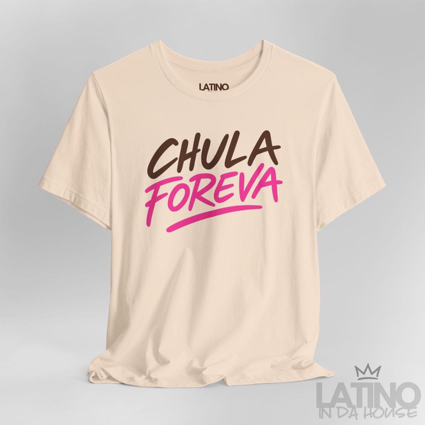 Close-up of soft cream t-shirt with the phrase "Chula Foreva" in bold brown and hot pink lettering, Latino In Da House.