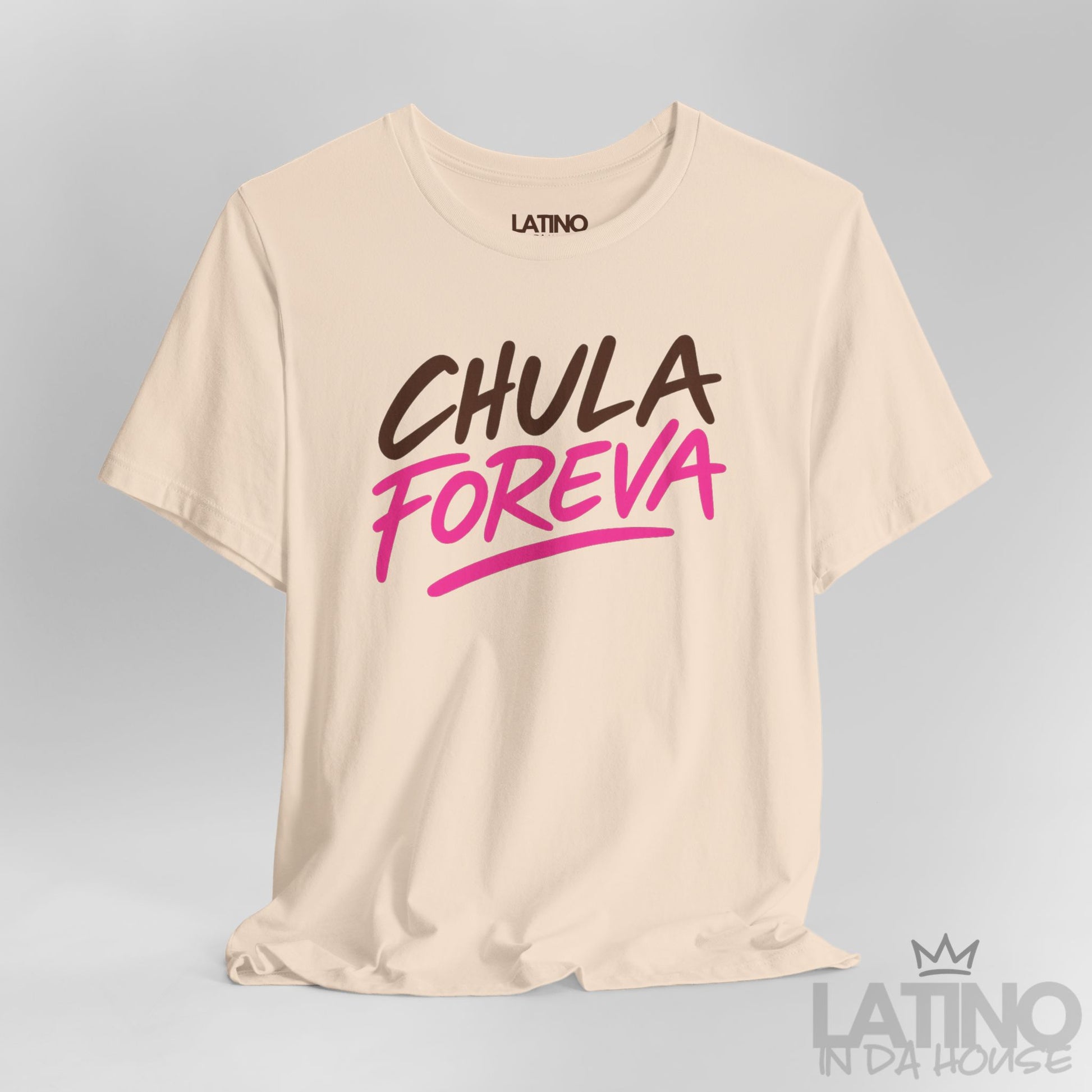 Close-up of soft cream t-shirt with the phrase "Chula Foreva" in bold brown and hot pink lettering, Latino In Da House.