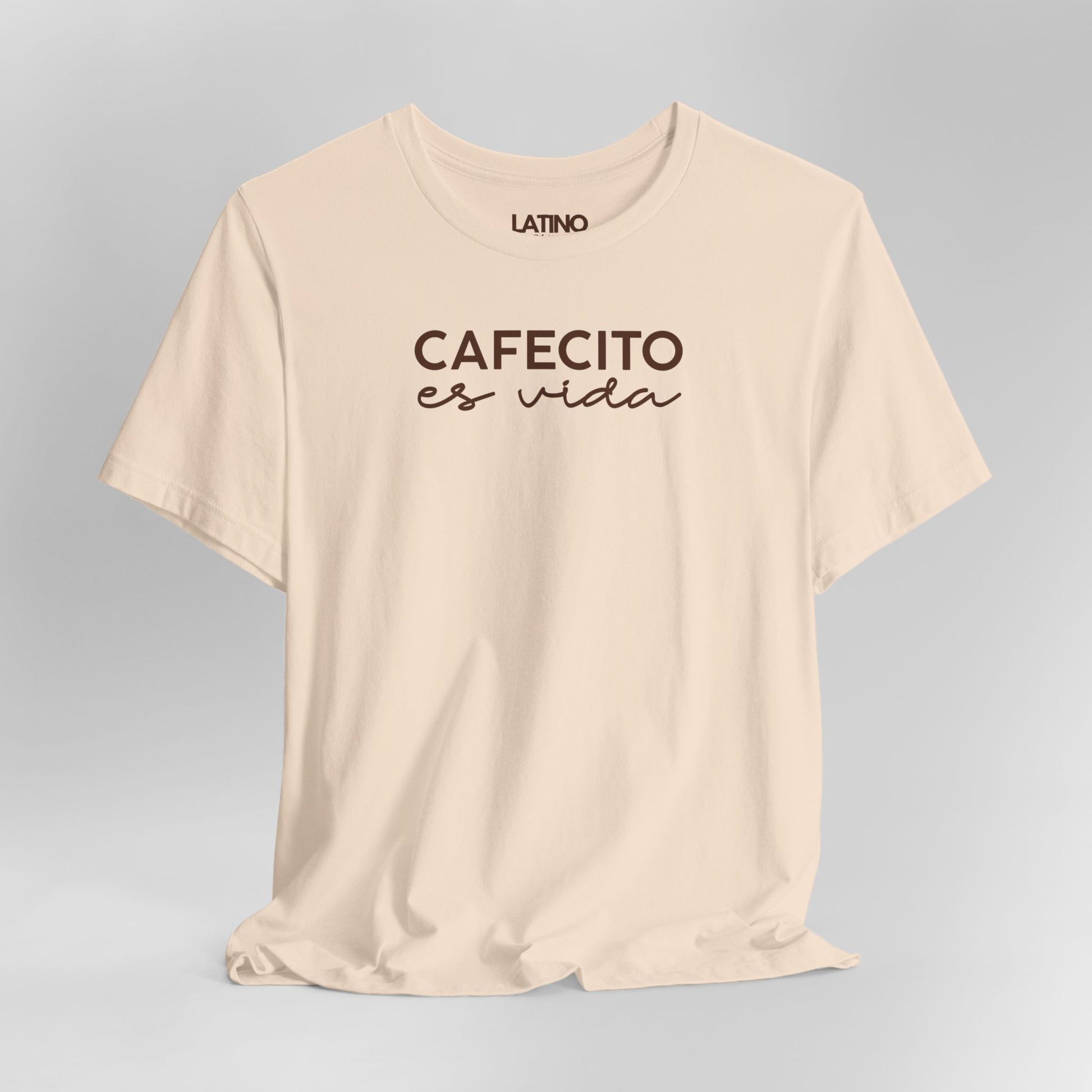 Close Up Cafecito Es Vida T-Shirt in soft cream with brown cursive text - Latino In
Da House