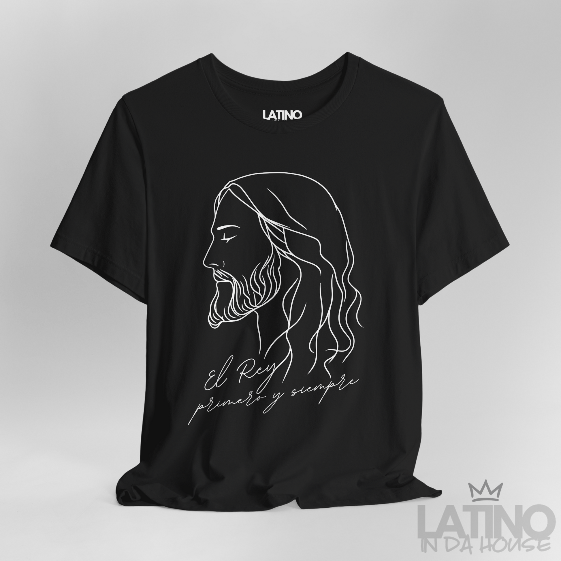Close-up of El Rey Primero y Siempre T-Shirt white print on soft black cotton. Latino In Da House