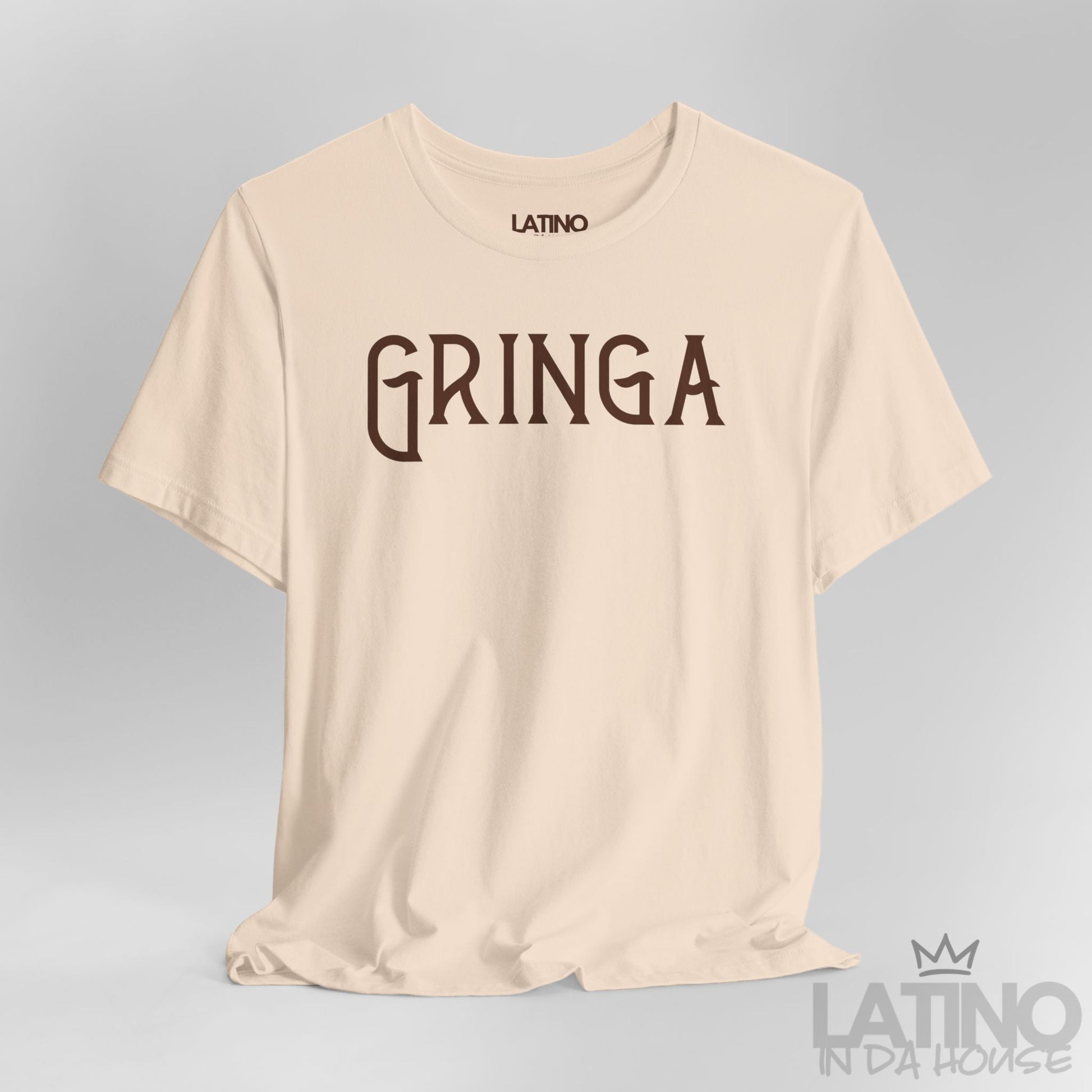 Close-up of soft cream Gringa T-Shirt design with bold gothic text. Latino In Da House 