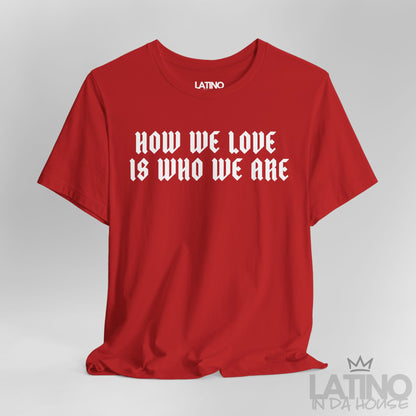 Close-up view of How We Love Is Who We Are T-Shirt in red with bold white gothic lettering. Latino In Da House 