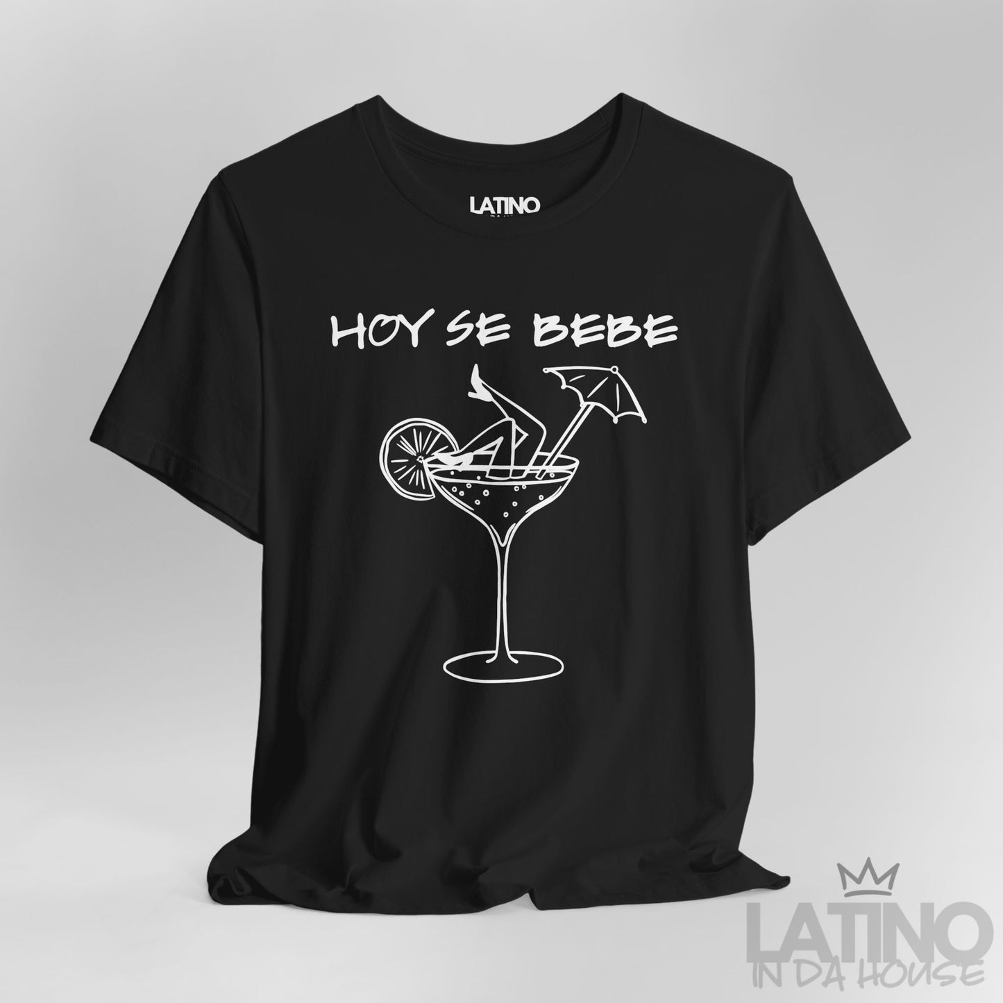 Close-up of black T-shirt design with Hoy Se Bebe phrase and cocktail graphic. Latino In Da House 