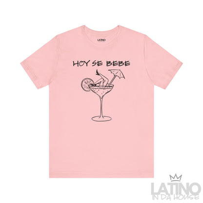 Pink T-shirt with “Hoy Se Bebe” text and cocktail glass with legs graphic. Latino In Da House 