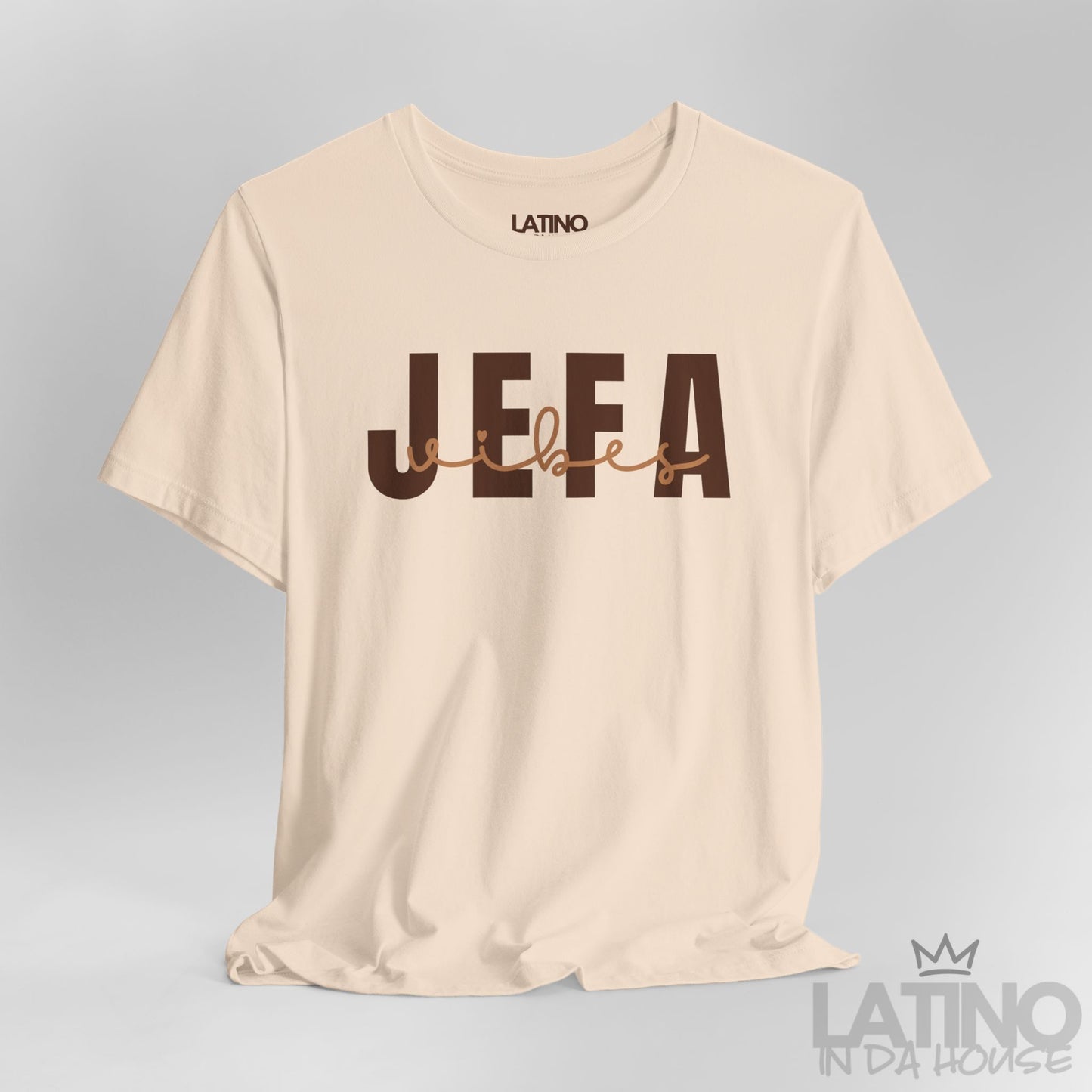 Close-up of Jefa Vibes text design in brown block and script letters on soft cream T-shirt. Latino In Da House 