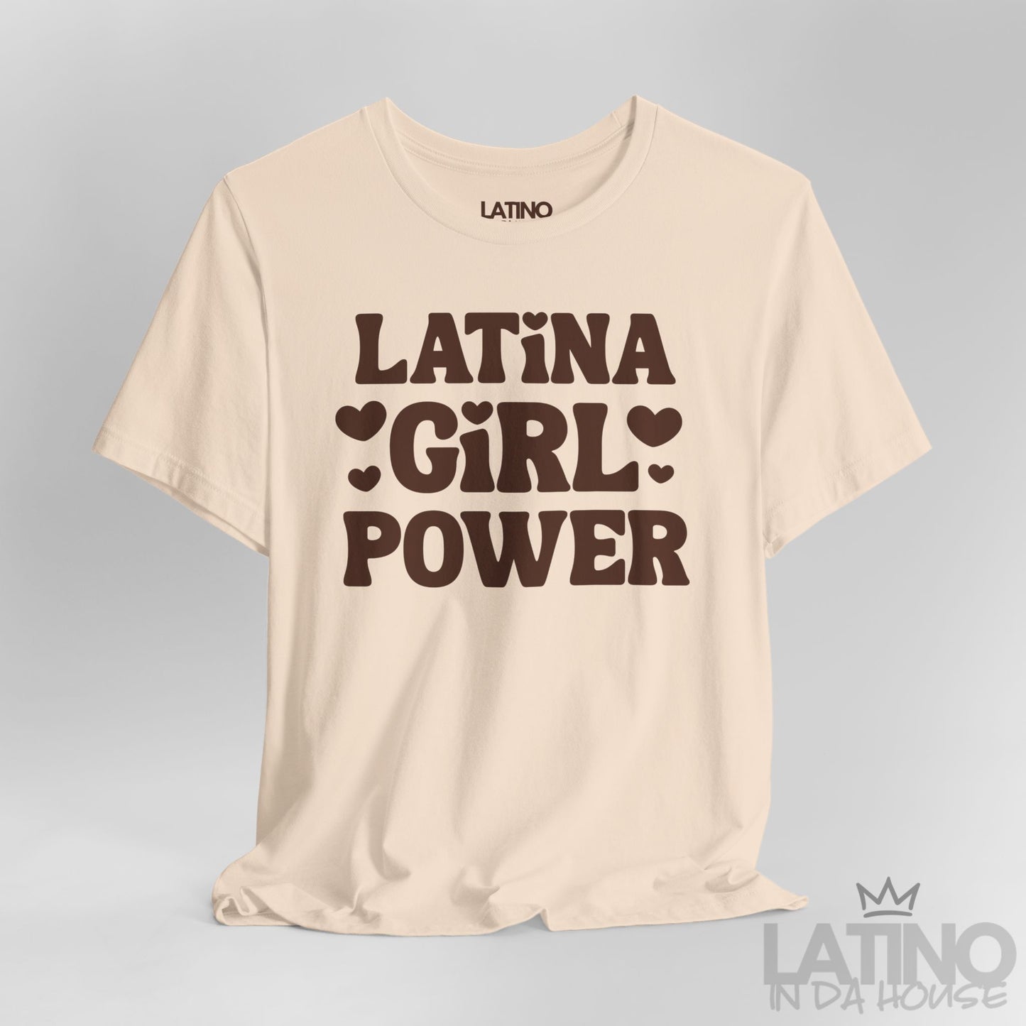 Close-up of soft cream T-shirt with brown “Latina Girl Power” text and heart accents. Latino In Da House 