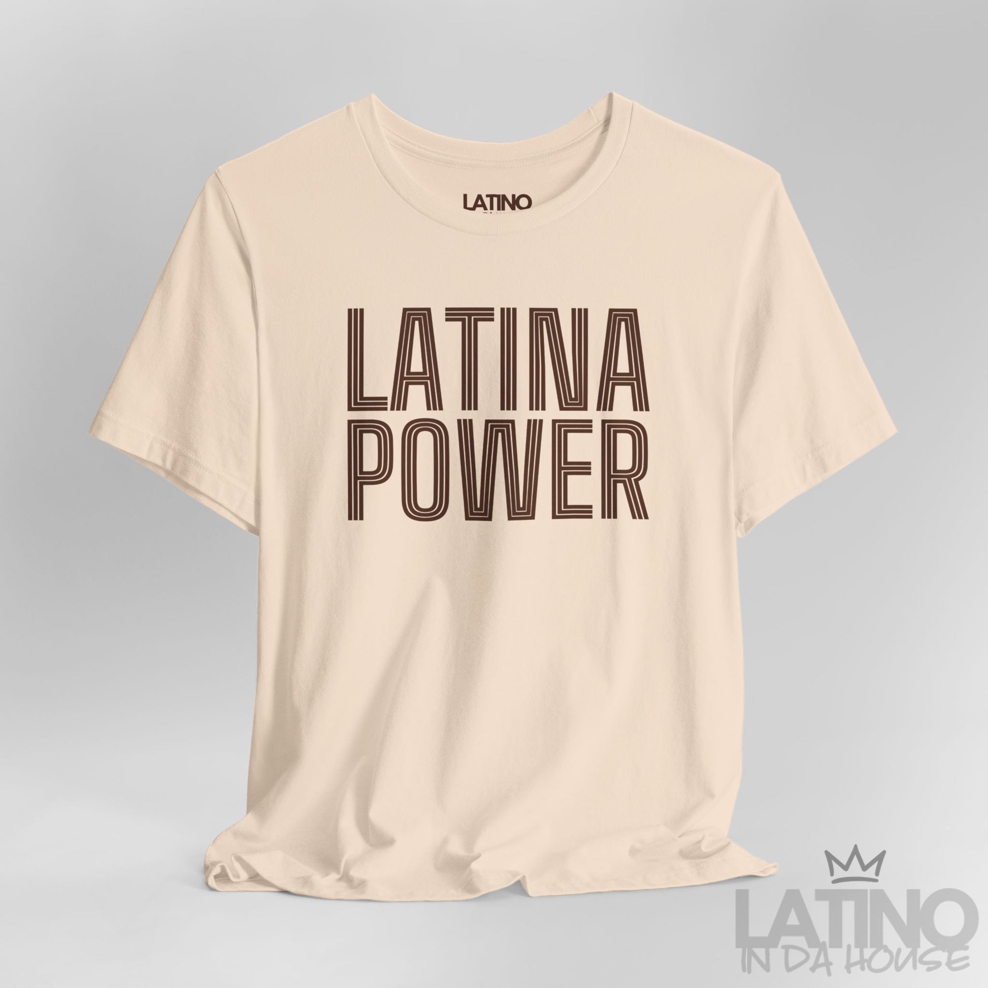 Close-up of soft cream Latina Power T-shirt featuring bold retro outlined font. Latino In Da House 