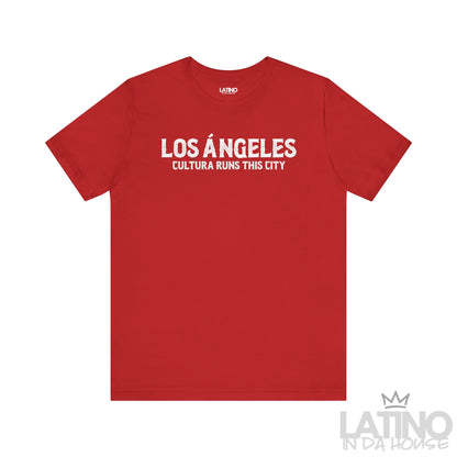 Los Ángeles Cultura Runs This City T-Shirt in vibrant red with white lettering — Latino pride design. Latino In Da House 