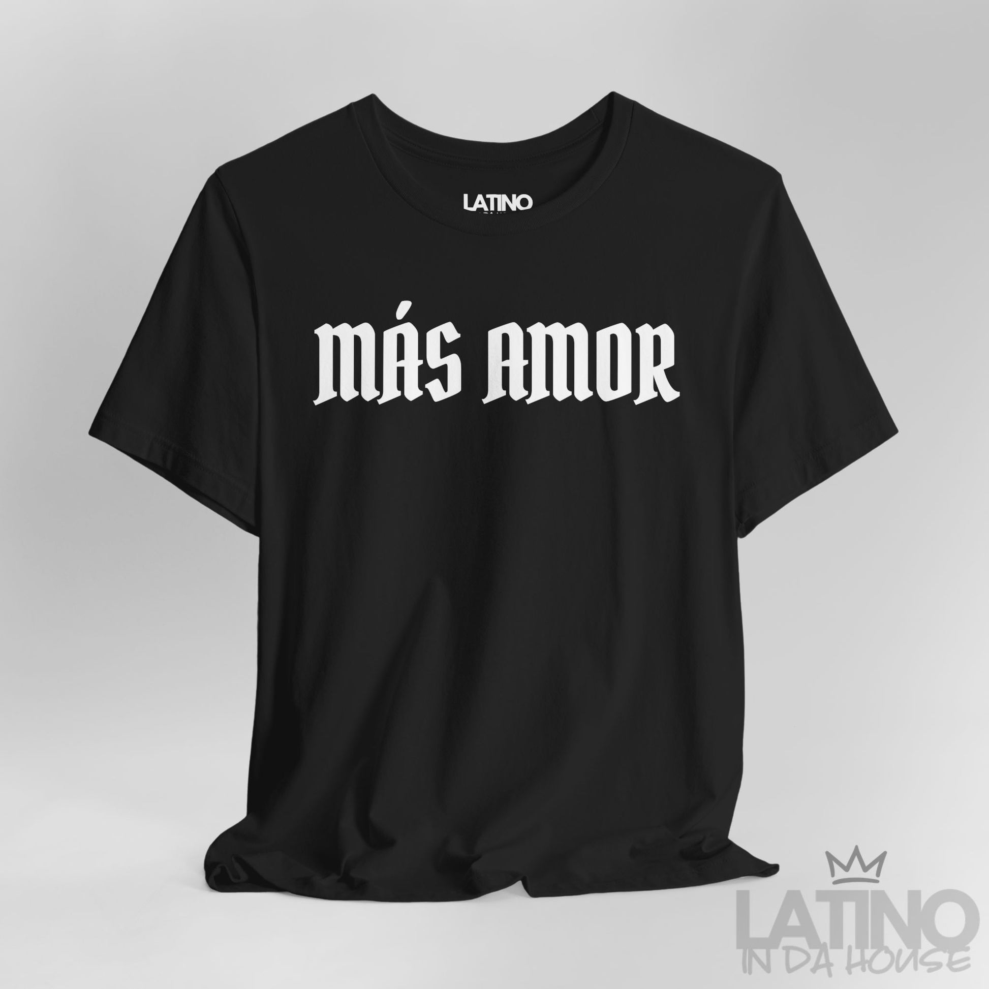 Close-up of black Más Amor T-shirt showing bold white gothic lettering. Latino In Da House