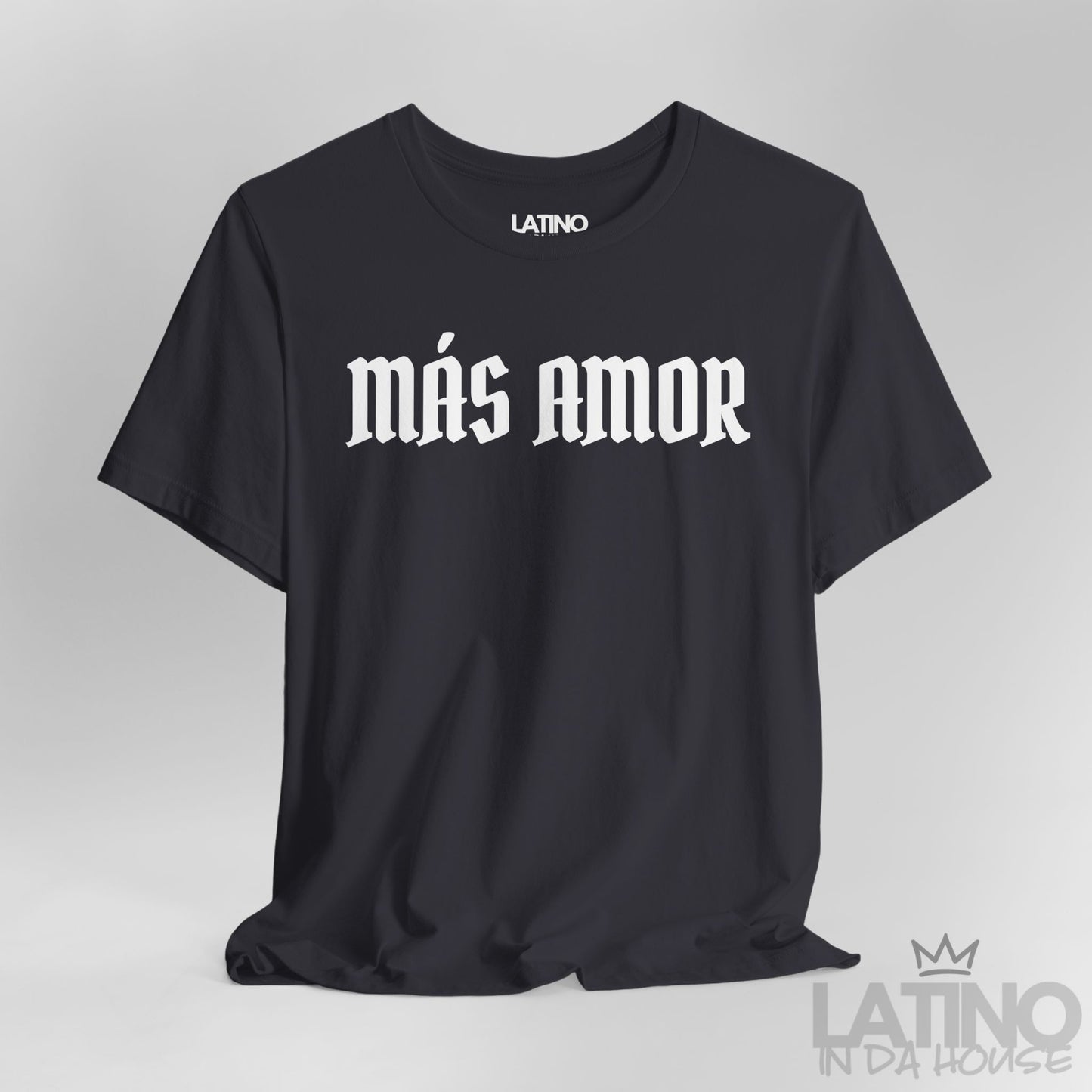 Close-up of dark grey Más Amor T-shirt with bold white gothic lettering. Latino In Da House 