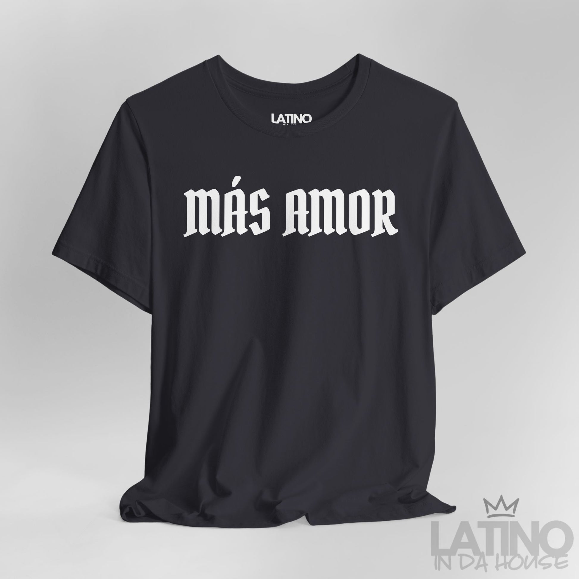 Close-up of dark grey Más Amor T-shirt with bold white gothic lettering. Latino In Da House 