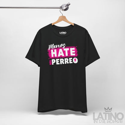 Black T-shirt on hanger featuring pink and white reggaeton-style text “Menos Hate Más Perreo,” trendy Latino fashion. Latino In Da House 
