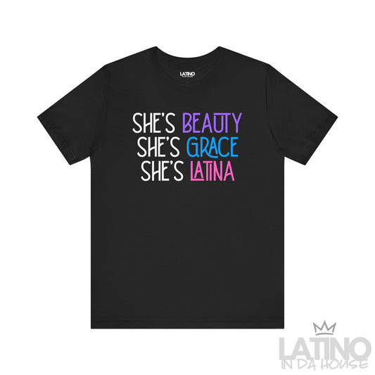 Black T-shirt with bold text that reads “She’s Beauty, She’s Grace, She’s Latina” in pink, blue, and purple font. Latino In Da House 