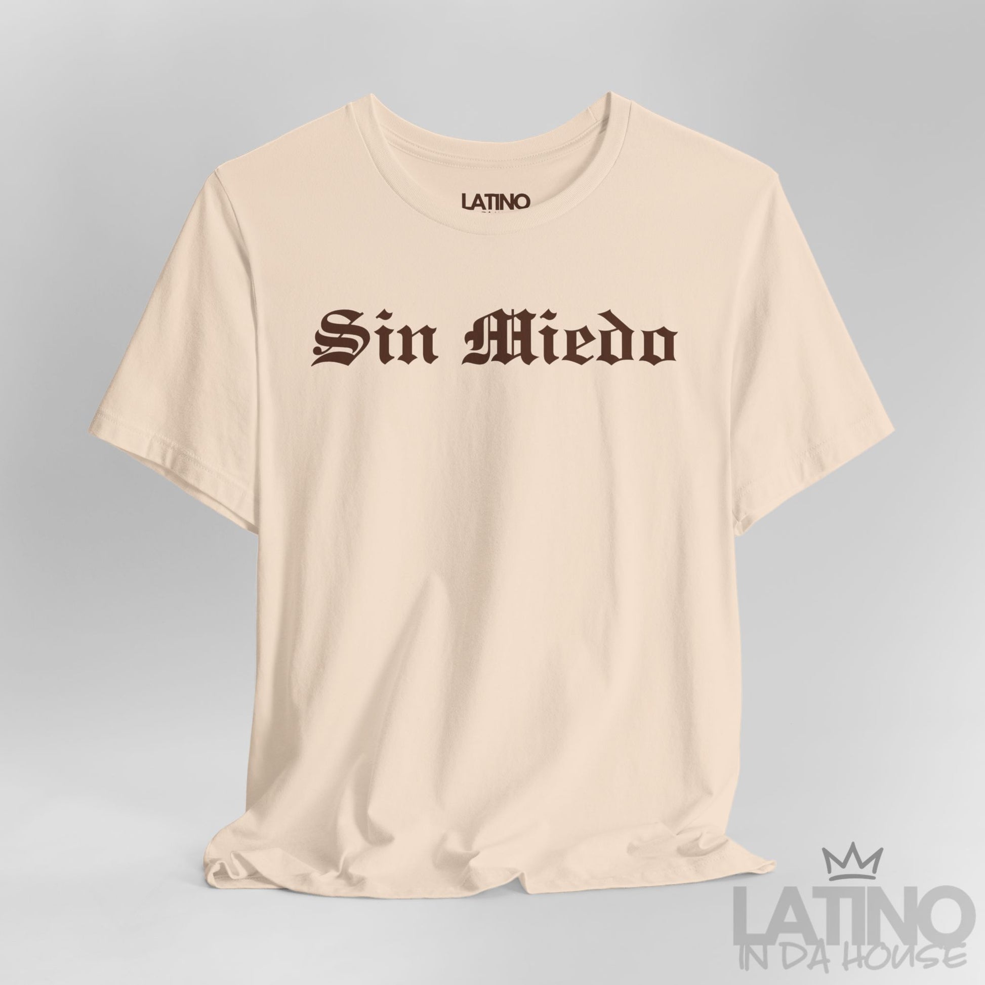 Close-up view of Sin Miedo T-Shirt in soft cream with bold brown gothic lettering. Latino In Da House 