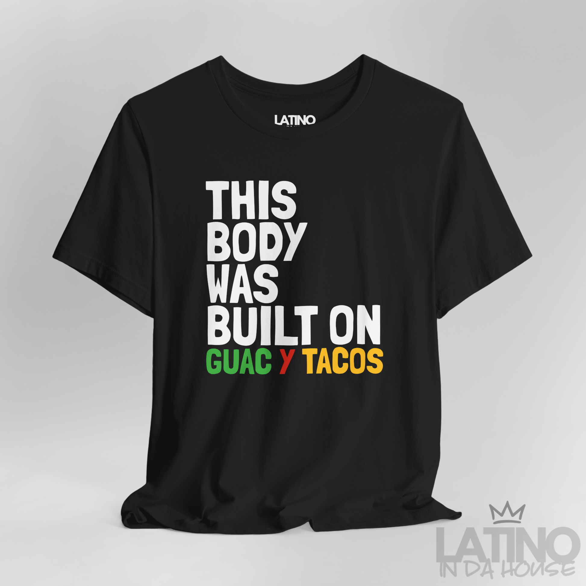 Close Up This Body Was Built on Guac y Tacos T-Shirt in black with bold white, green, red, and yellow text — funny Latino foodie tee. Latino In Da House 