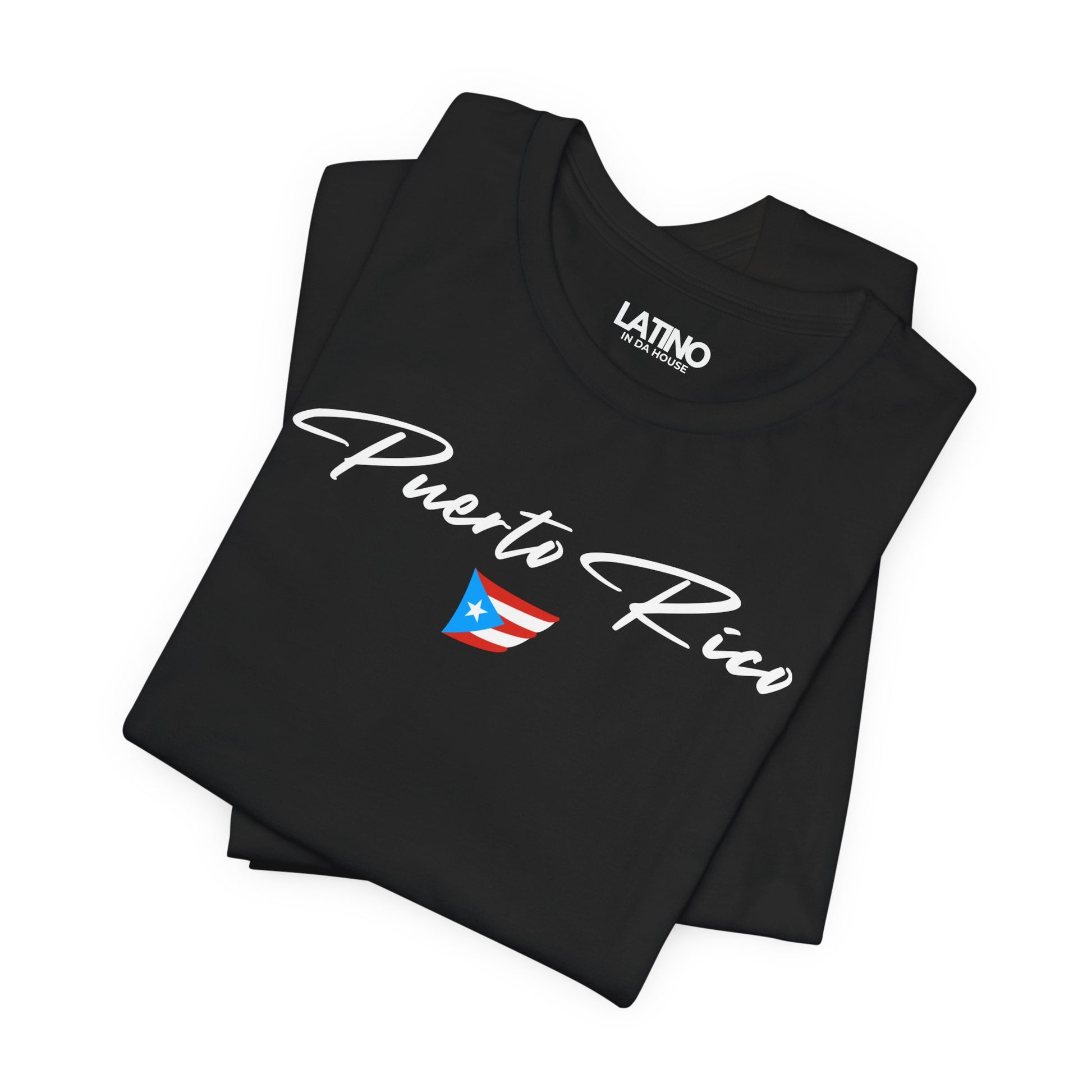 Folded Black T-shirt with white Puerto Rico script lettering and small Puerto
Rican flag graphic by Latino In Da House.