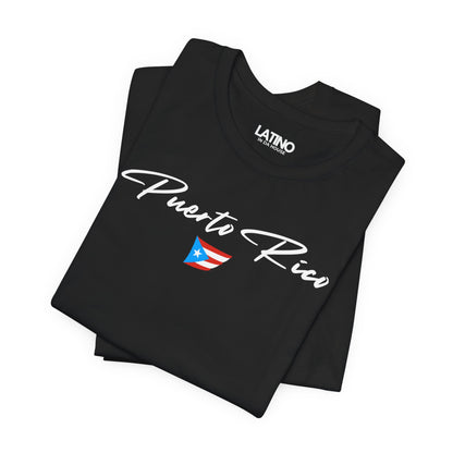 Folded Black T-shirt with white Puerto Rico script lettering and small Puerto
Rican flag graphic by Latino In Da House.