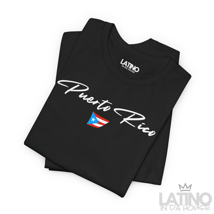Folded Black T-shirt with white Puerto Rico script lettering and small Puerto Rican flag graphic by Latino In Da House.
