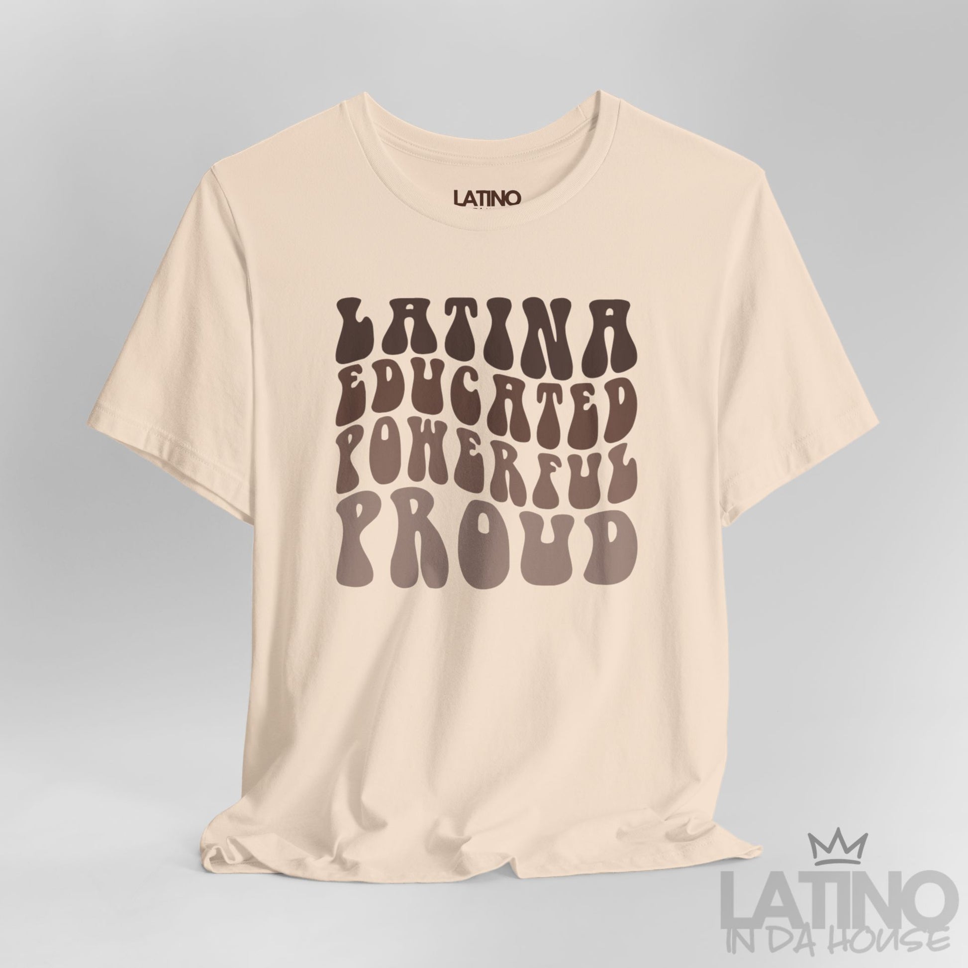 Close-up of retro bubble lettering ‘Latina Educated Powerful Proud’ on soft cream tee. Latino In Da House 