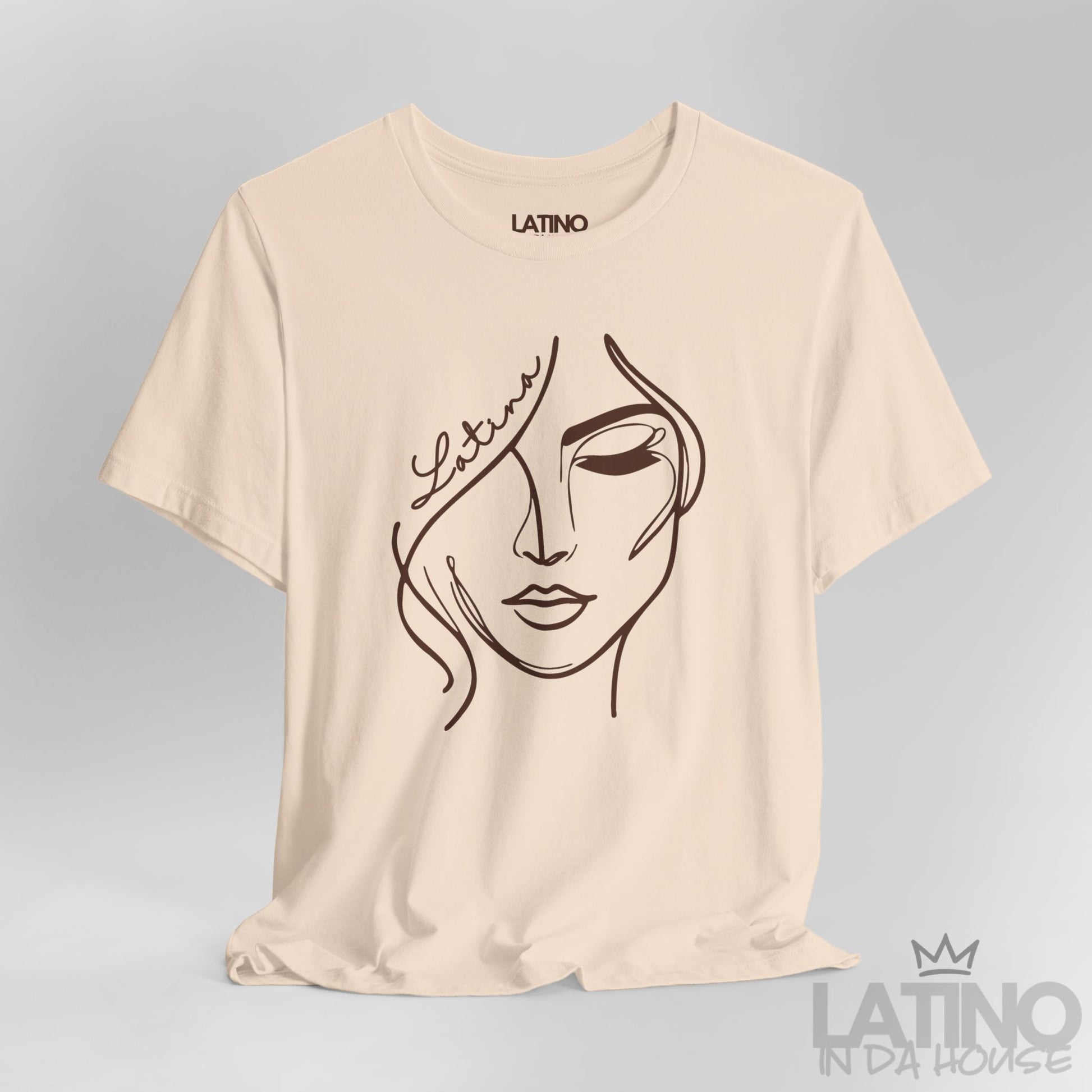 Close-up of “Latina” one-line face artwork on soft cream tee. Latino In Da House 